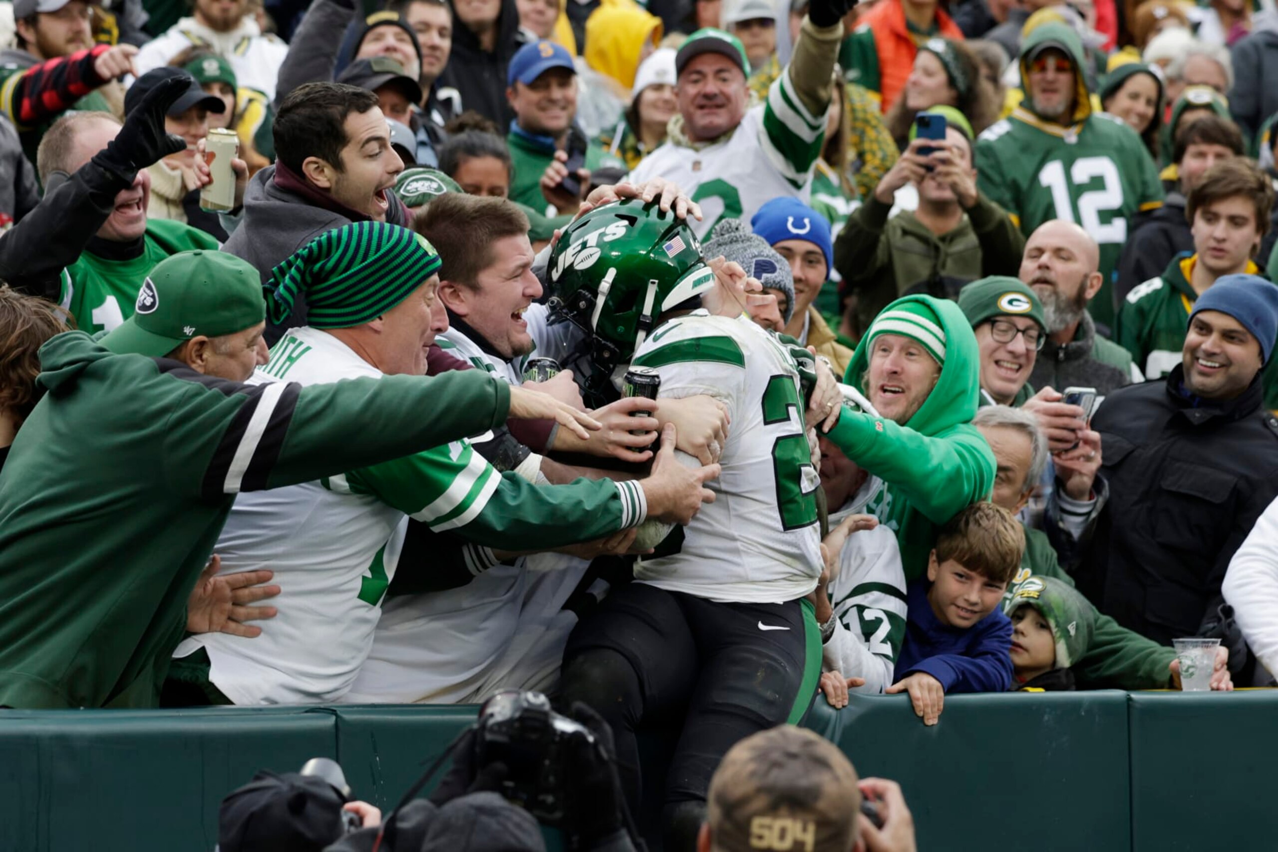 New York Jets running back Breece Hall jumps into the Jets' fans area to celebrate his 34-yard rushing touchdown during the second half of an NFL football game against the Green Bay Packers, Sunday, Oct. 16, 2022, in Green Bay, Wis. (AP Photo/Matt Ludtke)