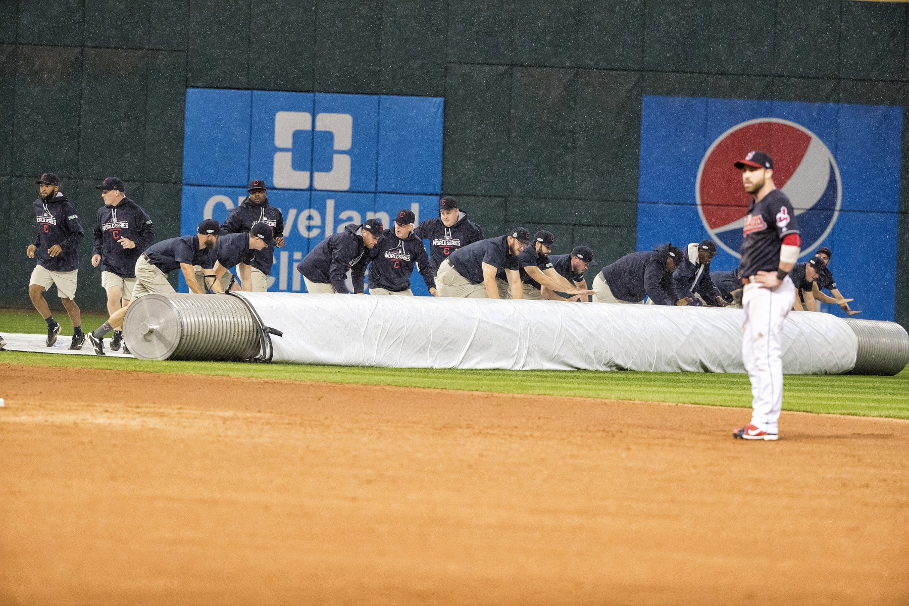 Baseball: World Series: View of grounds crew members rolling out tarp during rain delay after bottom of 9th inning during Chicago Cubs vs Cleveland Indians Game 7 at Progressive Field.
Cleveland, OH 11/2/2016
CREDIT: David E. Klutho (Photo by David E. Klutho /Sports Illustrated via Getty Images)
(Set Number: SI598 TK7 )