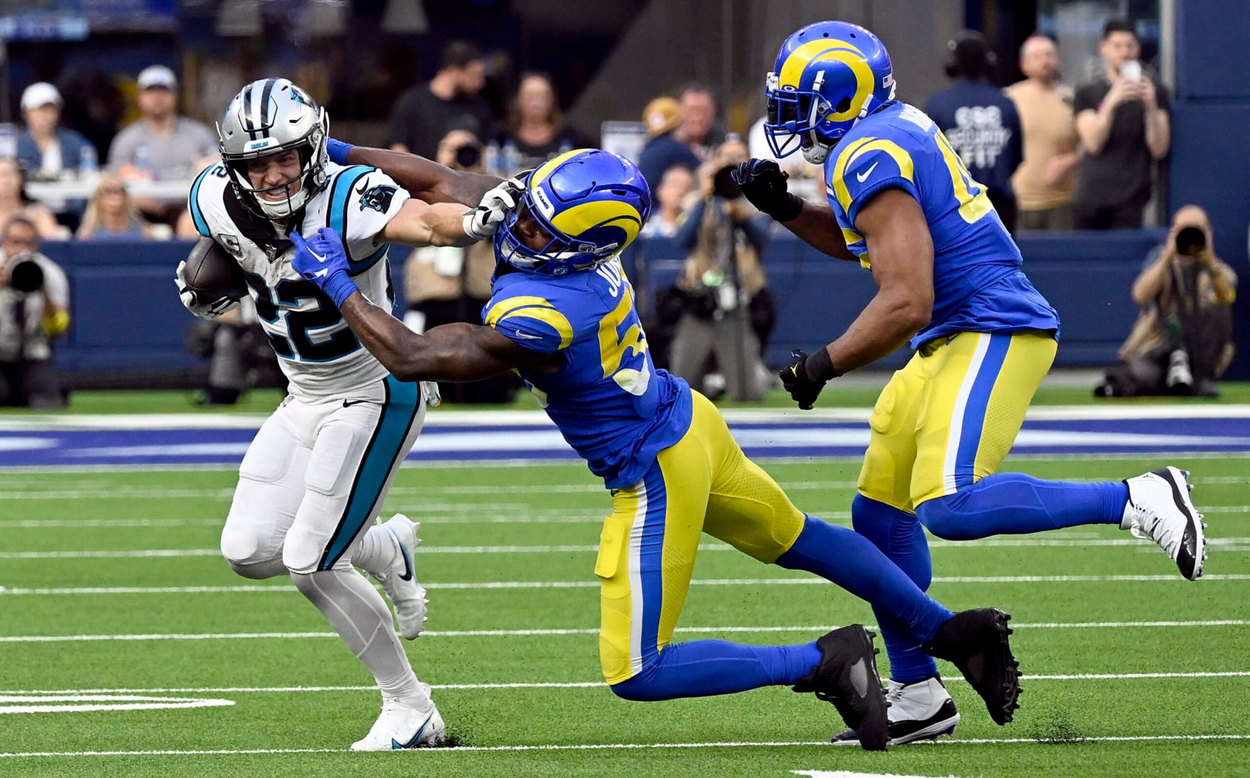 INGLEWOOD, CALIFORNIA - OCTOBER 16: Christian McCaffrey #22 of the Carolina Panthers stiff arms Ernest Jones #53 of the Los Angeles Rams during the fourth quarter at SoFi Stadium on October 16, 2022 in Inglewood, California. (Photo by John McCoy/Getty Images)