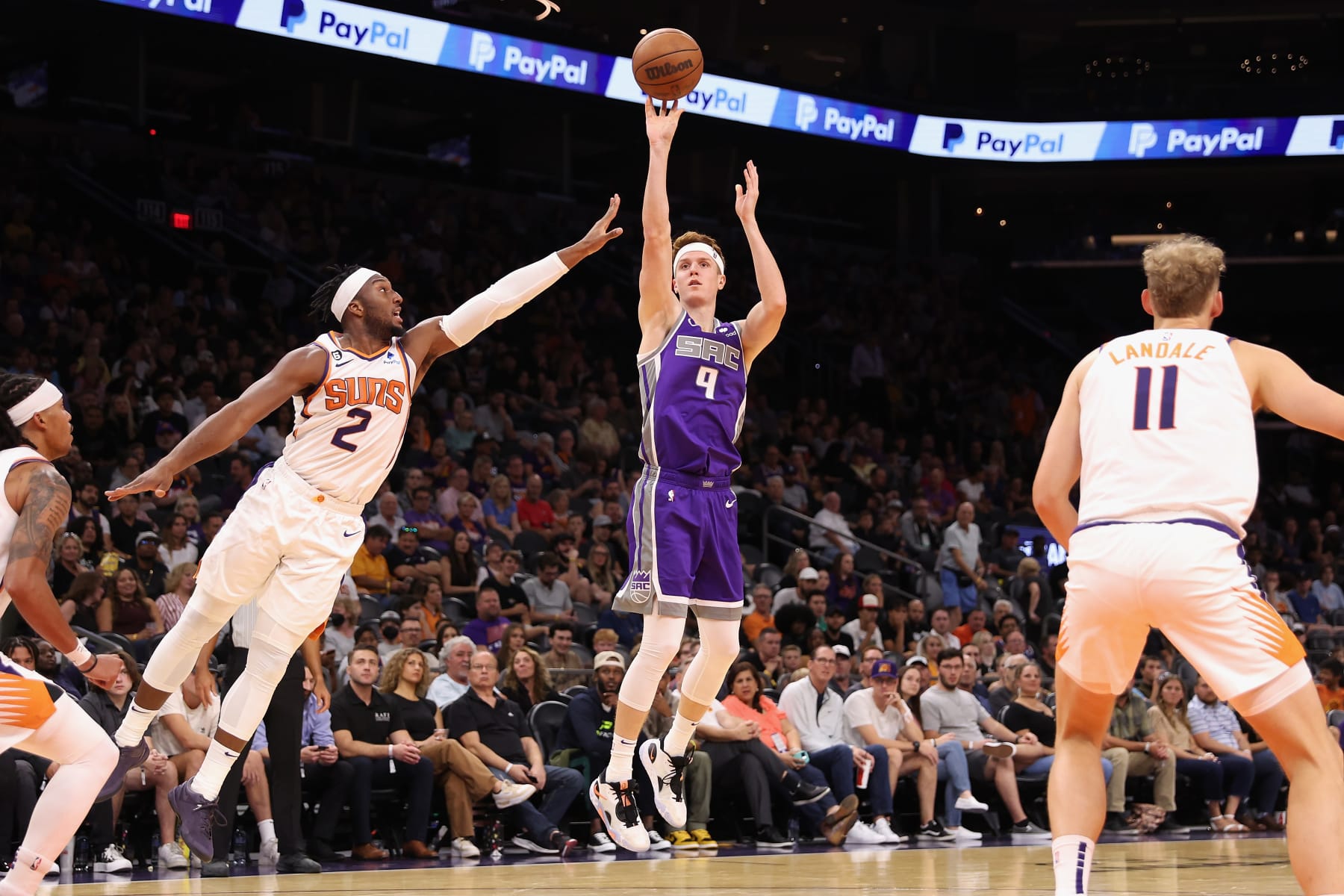 PHOENIX, ARIZONA - OCTOBER 12: Kevin Huerter #9 of the Sacramento Kings attempts a three-point shot ahead of Josh Okogie #2 of the Phoenix Suns during the first half of the preseason NBA game at Footprint Center on October 12, 2022 in Phoenix, Arizona. NOTE TO USER: User expressly acknowledges and agrees that, by downloading and or using this photograph, User is consenting to the terms and conditions of the Getty Images License Agreement.  (Photo by Christian Petersen/Getty Images)