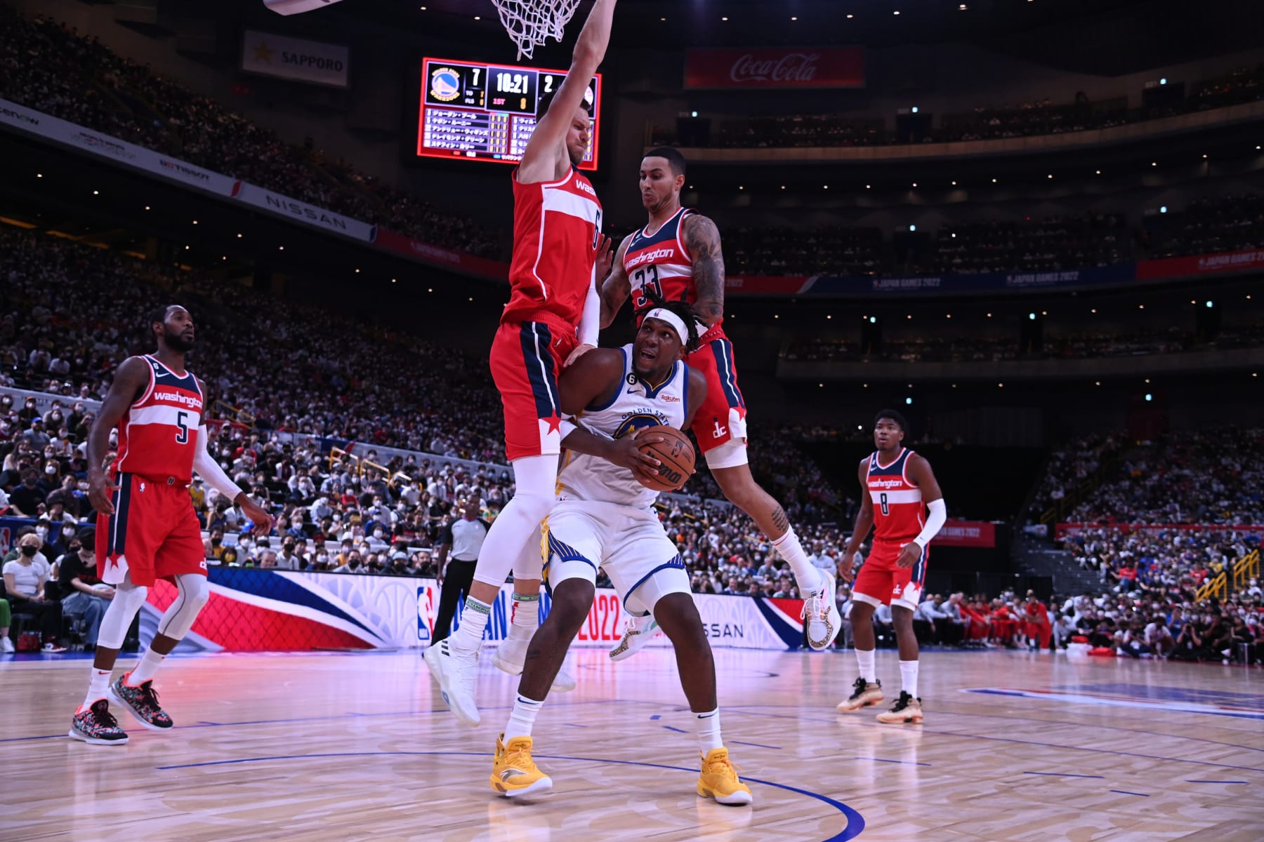 SAITAMA, JAPAN - OCTOBER 2: Kevon Looney of the Golden State Warriors looks to shoot against Kristaps Porzingis and Kyle Kuzma of the Washington Wizards addresses the crowd during the NBA Japan Games 2022 at Saitama Super Arena on October 2, 2022 in Saitama, Japan. NOTE TO USER: User expressly acknowledges and agrees that, by downloading and/or using this Photograph, user is consenting to the terms and conditions of the Getty Images License Agreement. Mandatory Copyright Notice: Copyright 2022 NBAE (Photo by Noah Graham/NBAE via Getty Images)
