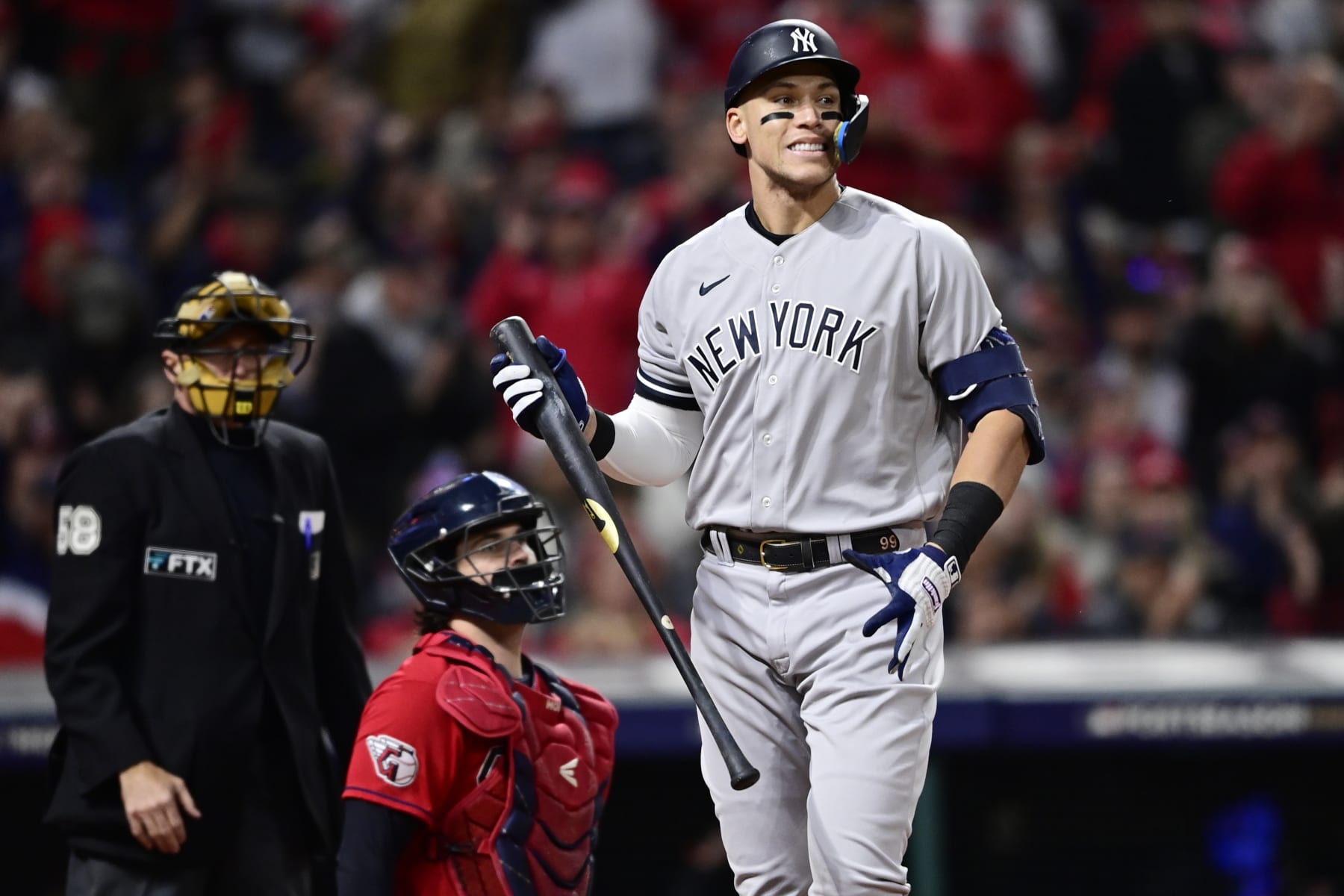 New York Yankees' Aaron Judge walks away after striking out, next to Cleveland Guardians catcher Austin Hedges during the first inning of Game 3 of a baseball AL Division Series, Saturday, Oct. 15, 2022, in Cleveland. (AP Photo/David Dermer)