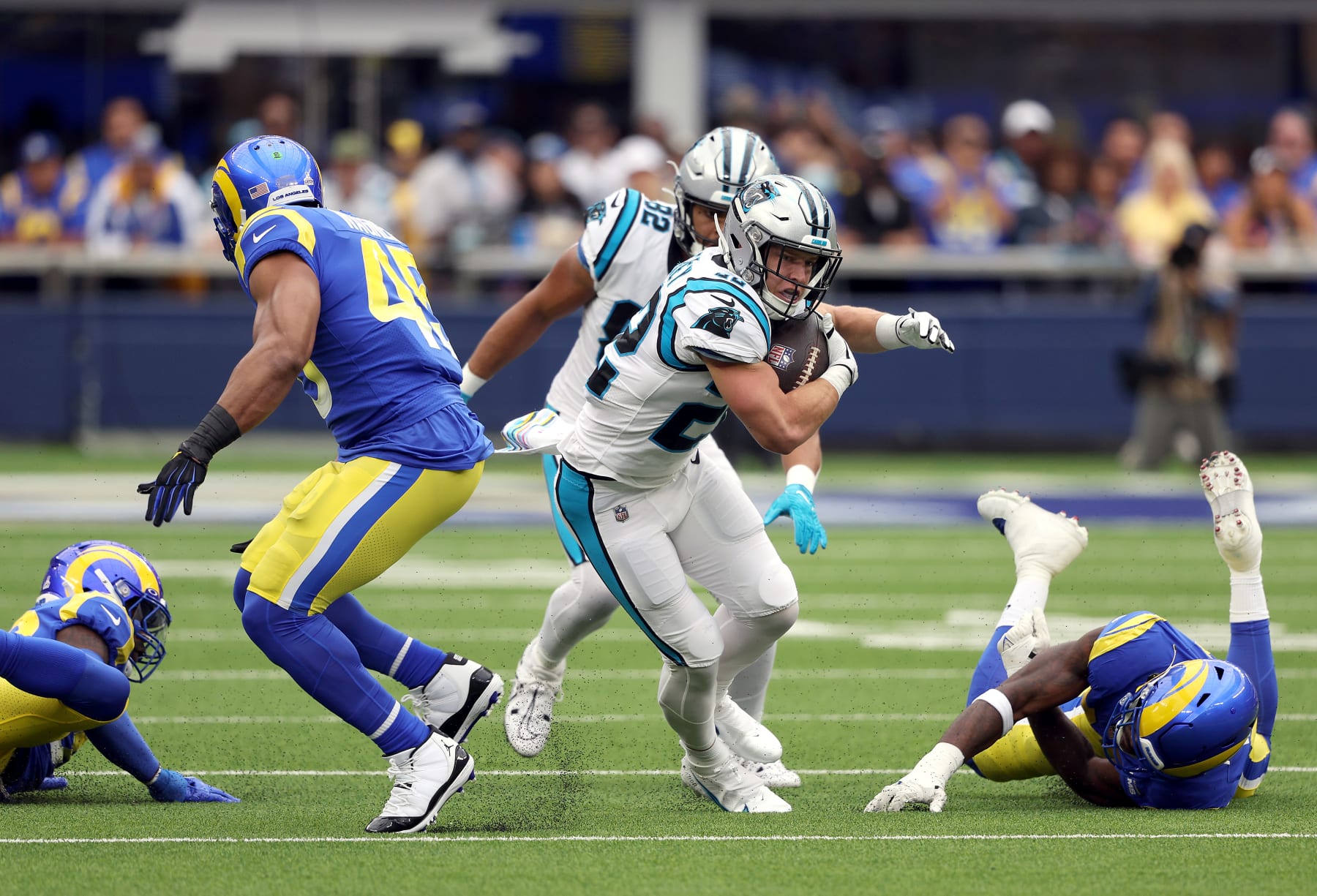 INGLEWOOD, CALIFORNIA - OCTOBER 16: Christian McCaffrey #22 of the Carolina Panthers rushes for yardage past Bobby Wagner #45 of the Los Angeles Rams in the first quarter of a game at SoFi Stadium on October 16, 2022 in Inglewood, California. (Photo by Harry How/Getty Images)