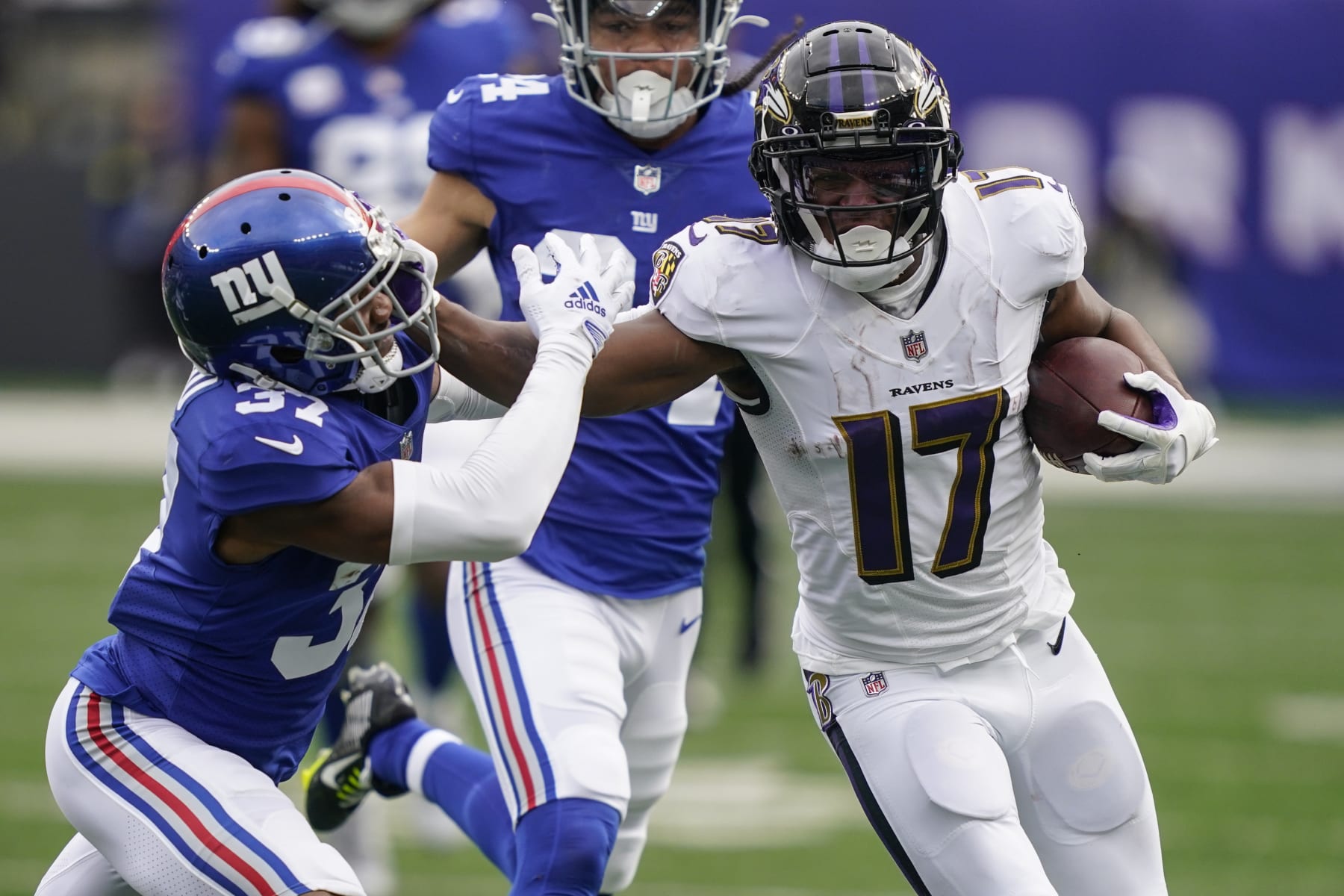 Baltimore Ravens' Kenyan Drake (17) stiff-arms New York Giants' Fabian Moreau (37) during the first half of an NFL football game Sunday, Oct. 16, 2022, in East Rutherford, N.J. (AP Photo/John Minchillo)