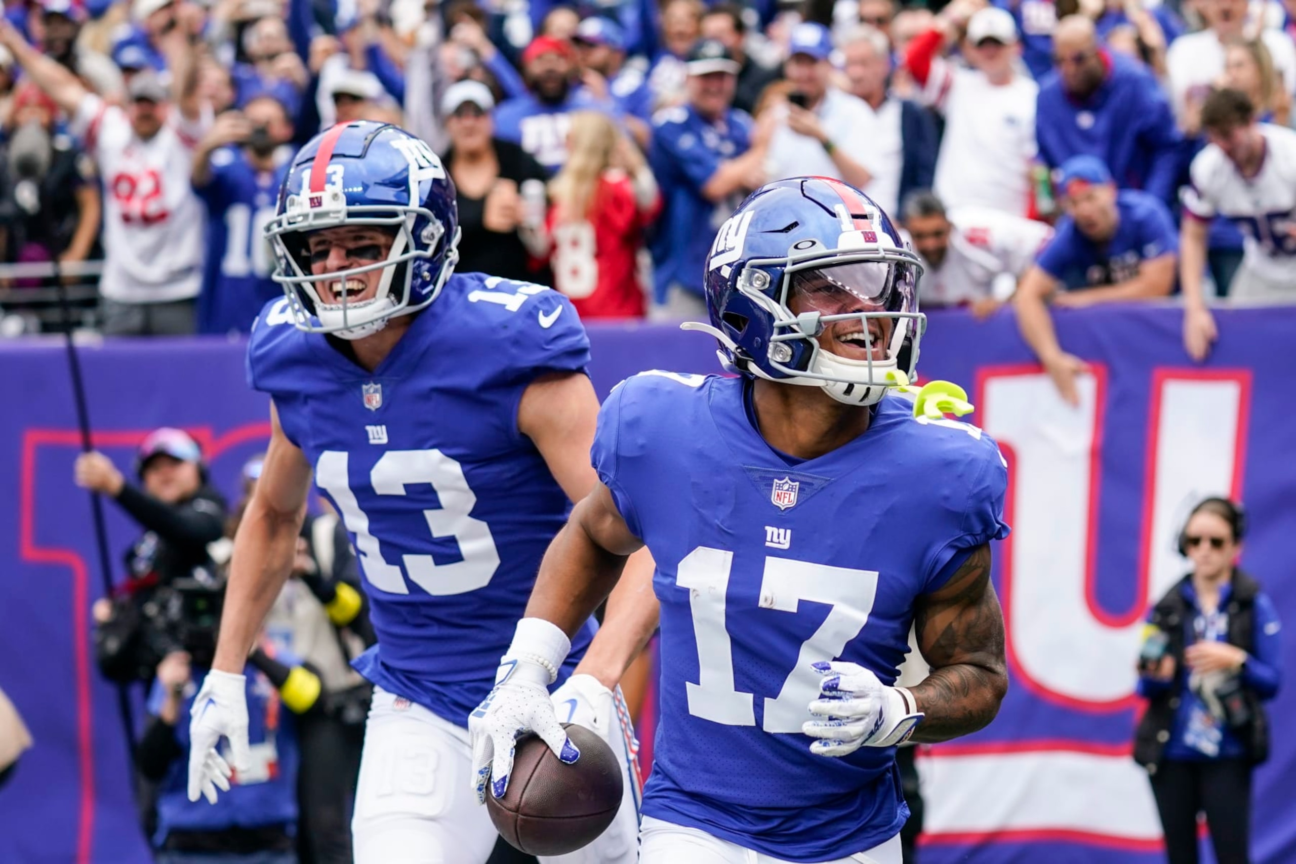 New York Giants' David Sills V (13) celebrates with Wan'Dale Robinson (17) after Robinson scored a touchdown during the first half of an NFL football game against the Baltimore Ravens, Sunday, Oct. 16, 2022, in East Rutherford, N.J. (AP Photo/Seth Wenig)