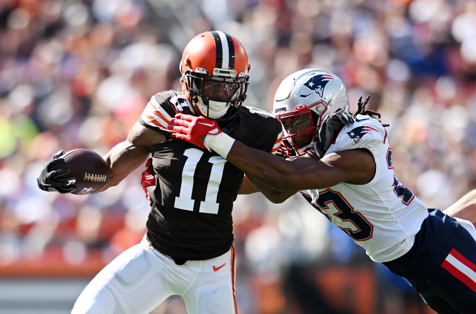 CLEVELAND, OHIO - OCTOBER 16: Donovan Peoples-Jones #11 of the Cleveland Browns stiff arms Kyle Dugger #23 of the New England Patriots during the first quarter at FirstEnergy Stadium on October 16, 2022 in Cleveland, Ohio. (Photo by Nick Cammett/Getty Images)