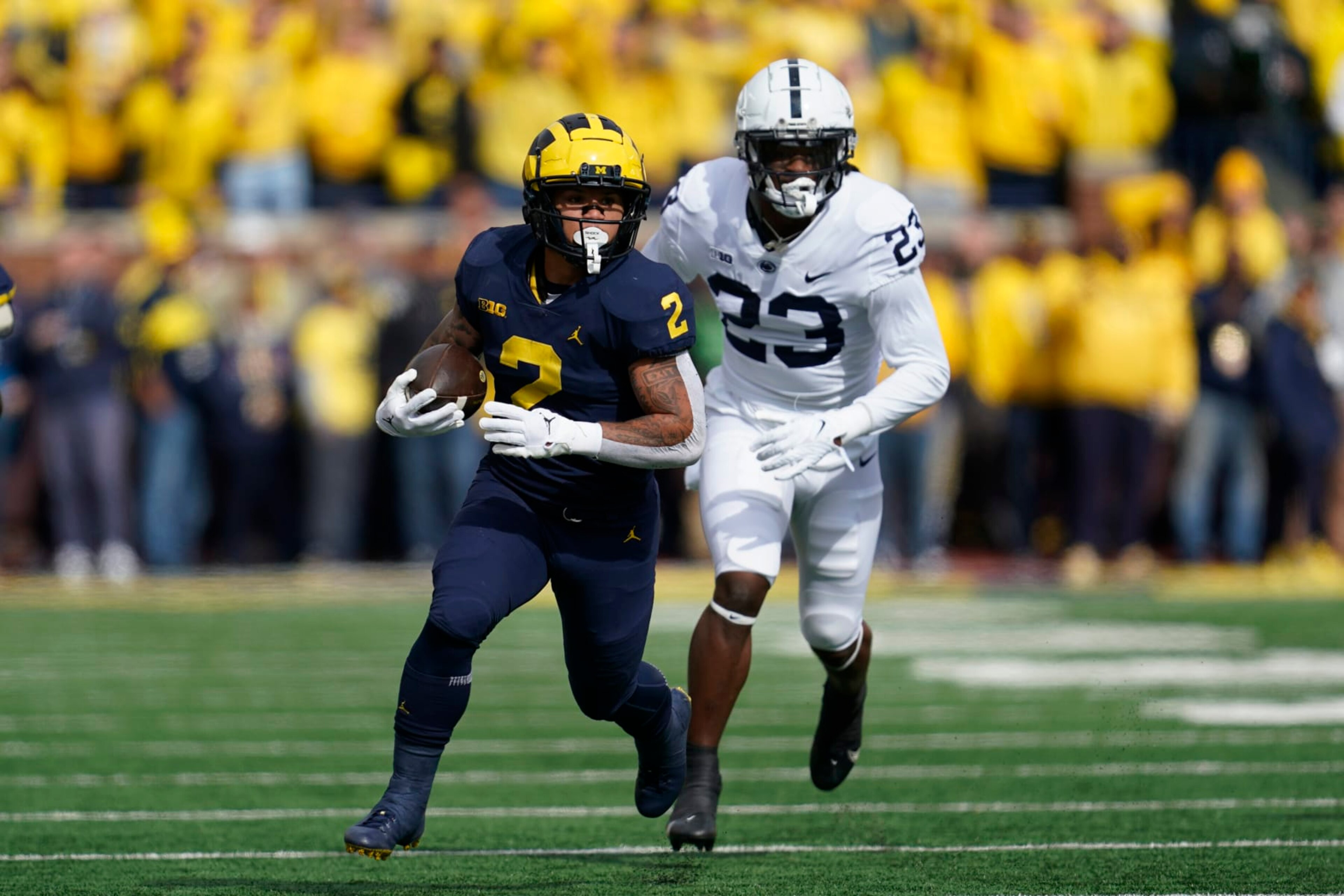 Michigan running back Blake Corum (2) runs the ball as Penn State linebacker Curtis Jacobs (23) chases in the first half of an NCAA college football game in Ann Arbor, Mich., Saturday, Oct. 15, 2022. (AP Photo/Paul Sancya) Michigan running back Blake Corum (2) runs the ball as Penn State linebacker Curtis Jacobs (23) chases in the first half of an NCAA college football game in Ann Arbor, Mich., Saturday, Oct. 15, 2022. (AP Photo/Paul Sancya)