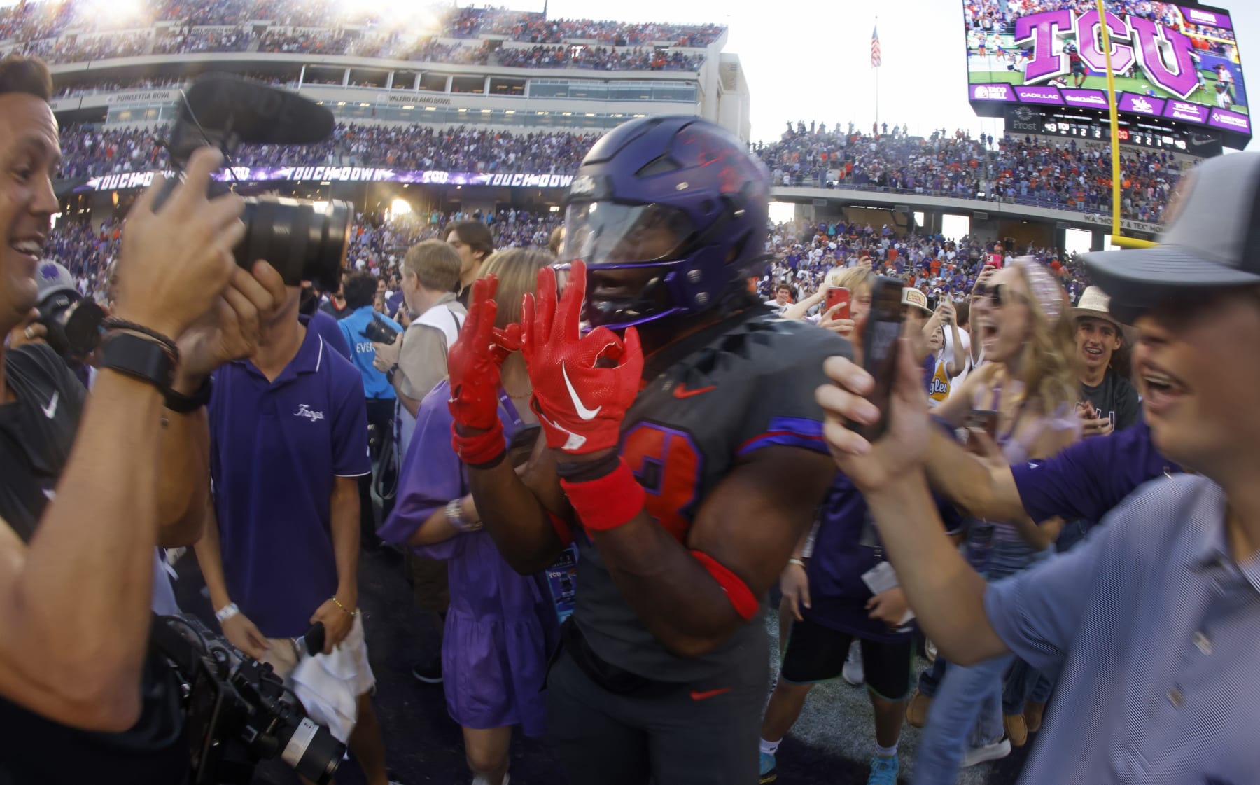 FORT WORTH, TX - OCTOBER 15: Kendre Miller #33 of the TCU Horned Frogs celebrates with fans following the teams 43-40 double overtime win against the Oklahoma State Cowboys at Amon G. Carter Stadium on October 15, 2022 in Fort Worth, Texas. (Photo by Ron Jenkins/Getty Images)