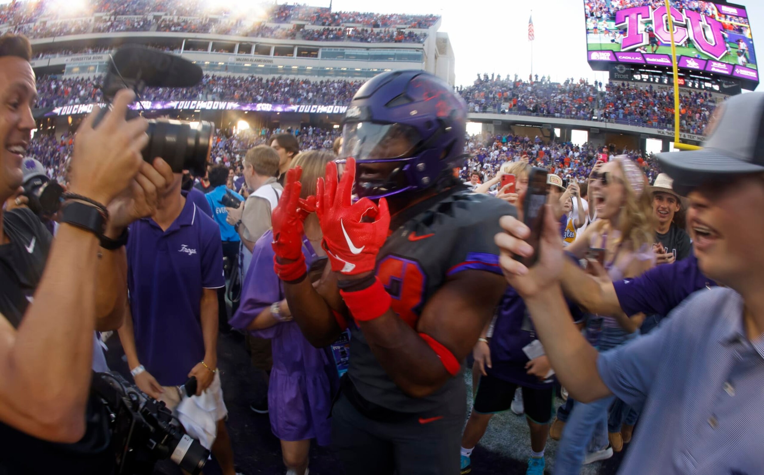 FORT WORTH, TX - OCTOBER 15: Kendre Miller #33 of the TCU Horned Frogs celebrates with fans following the teams 43-40 double overtime win against the Oklahoma State Cowboys at Amon G. Carter Stadium on October 15, 2022 in Fort Worth, Texas. (Photo by Ron Jenkins/Getty Images)