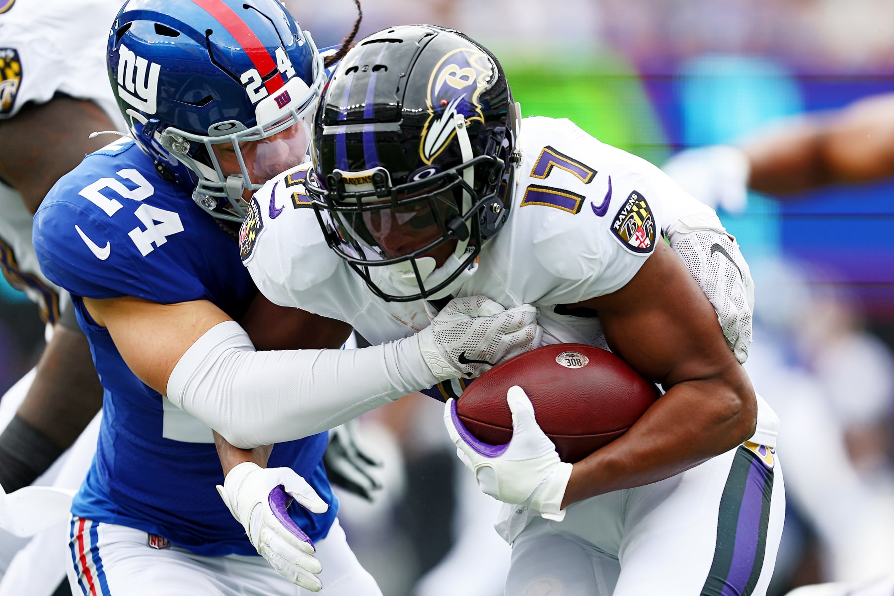 EAST RUTHERFORD, NEW JERSEY - OCTOBER 16: Kenyan Drake #17 of the Baltimore Ravens runs the ball and is tackled by Dane Belton #24 of the New York Giants during the first quarter at MetLife Stadium on October 16, 2022 in East Rutherford, New Jersey. (Photo by Elsa/Getty Images)