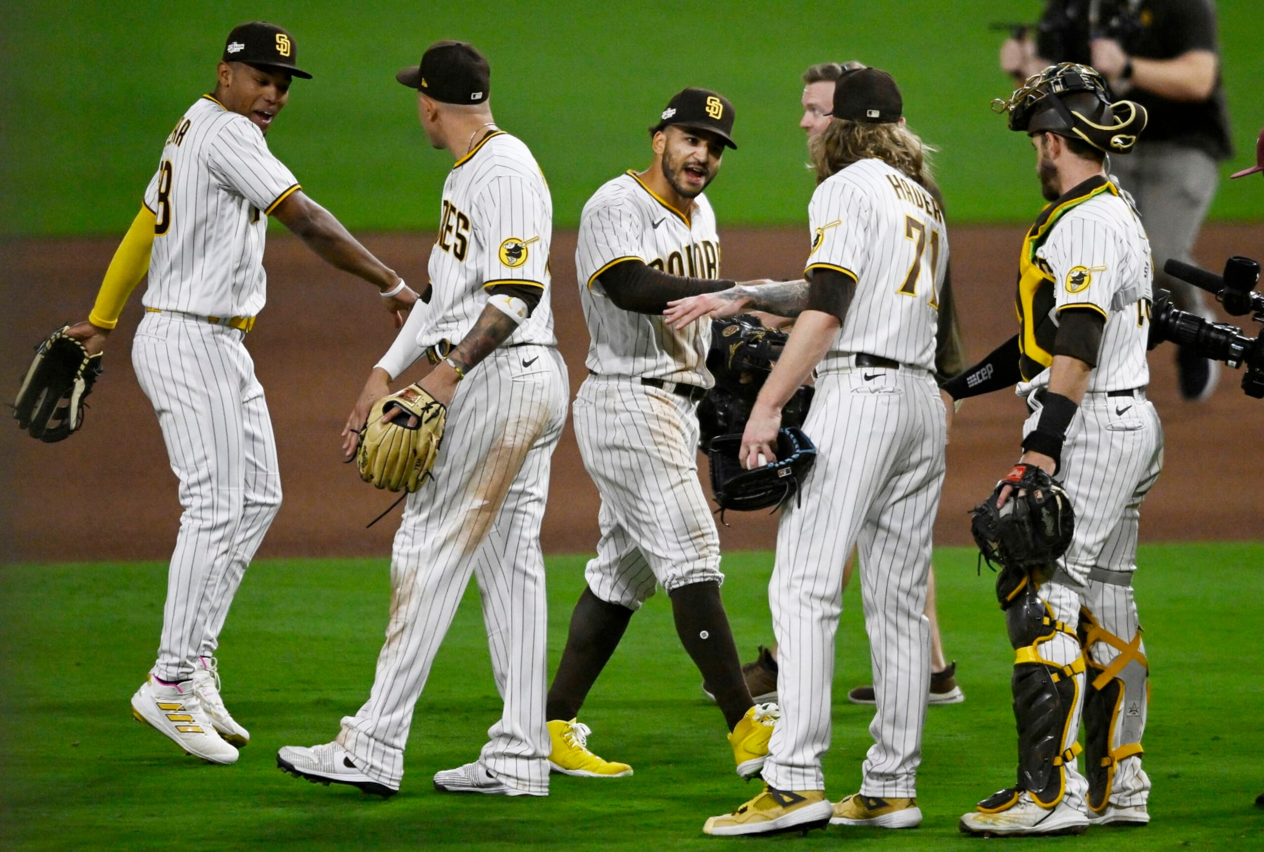 SAN DIEGO, CALIFORNIA - OCTOBER 14: Trent Grisham #2 of the San Diego Padres celebrates with teammates after defeating the Los Angeles Dodgers in game three of the National League Division Series at PETCO Park on October 14, 2022 in San Diego, California. (Photo by Denis Poroy/Getty Images)