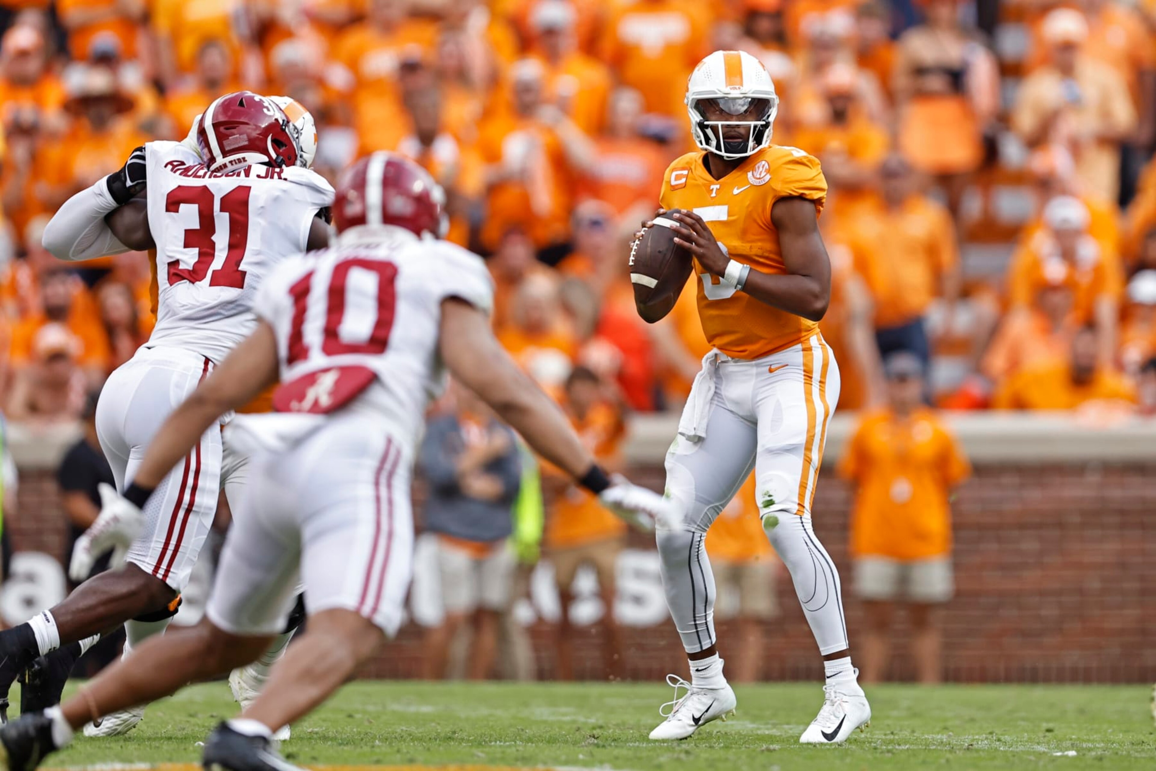 Tennessee quarterback Hendon Hooker (5) looks for a receiver during the first half of an NCAA college football game against Alabama Saturday, Oct. 15, 2022, in Knoxville, Tenn. (AP Photo/Wade Payne) Tennessee quarterback Hendon Hooker (5) looks for a receiver during the first half of an NCAA college football game against Alabama Saturday, Oct. 15, 2022, in Knoxville, Tenn. (AP Photo/Wade Payne)