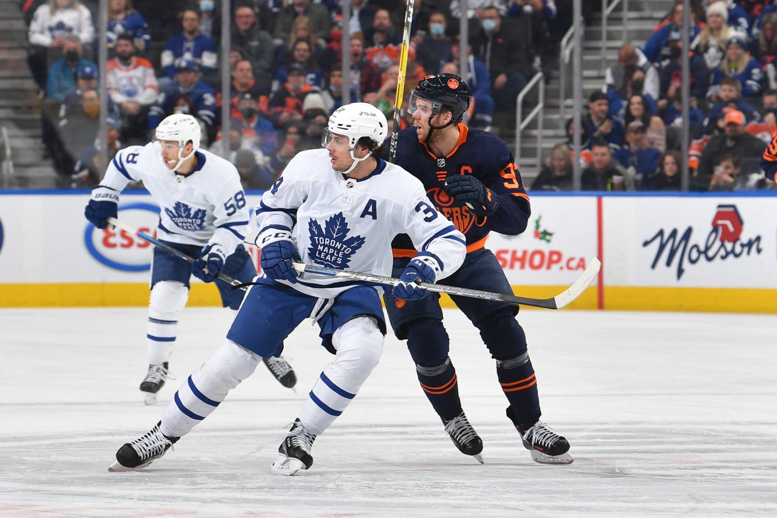 EDMONTON, AB - DECEMBER 14: Connor McDavid #97 of the Edmonton Oilers battles for the puck against Auston Matthews #34 of the Toronto Maple Leafs on December 14, 2021 at Rogers Place in Edmonton, Alberta, Canada. (Photo by Andy Devlin/NHLI via Getty Images)