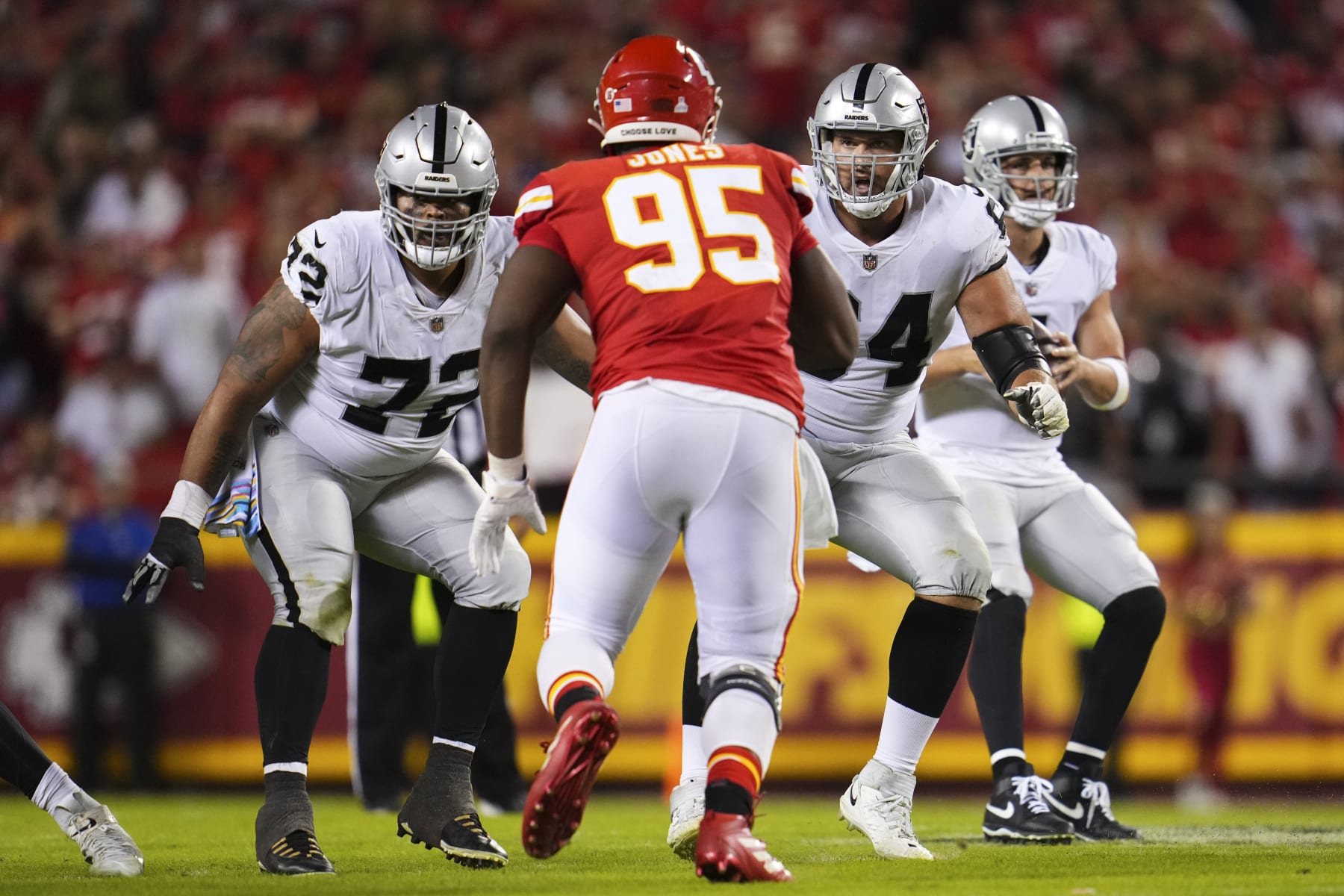KANSAS CITY, MO - OCTOBER 10: Jermaine Eluemunor #72 of the Las Vegas Raiders and Alex Bars #64 defend against Chris Jones #95 of the Kansas City Chiefs at GEHA Field at Arrowhead Stadium on October 10, 2022 in Kansas City, Missouri. (Photo by Cooper Neill/Getty Images)