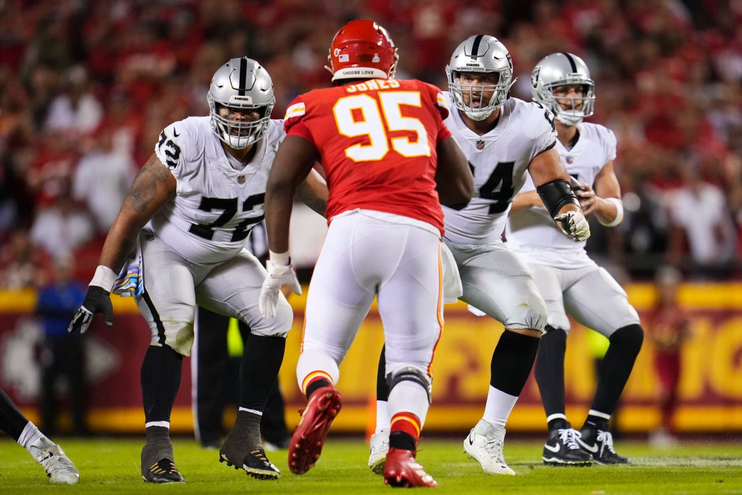 KANSAS CITY, MO - OCTOBER 10: Jermaine Eluemunor #72 of the Las Vegas Raiders and Alex Bars #64 defend against Chris Jones #95 of the Kansas City Chiefs at GEHA Field at Arrowhead Stadium on October 10, 2022 in Kansas City, Missouri. (Photo by Cooper Neill/Getty Images)