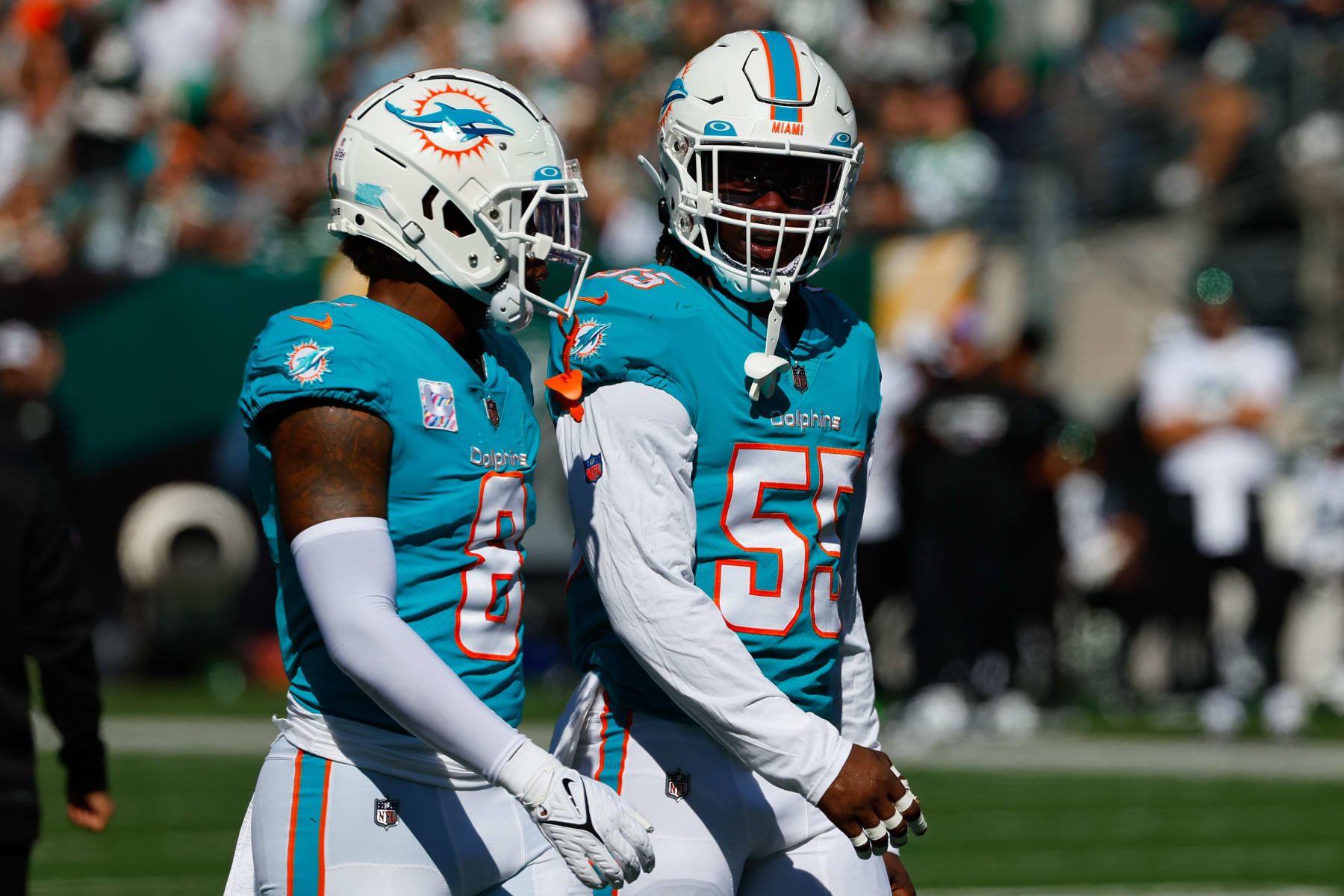 EAST RUTHERFORD, NJ - OCTOBER 09:  Miami Dolphins linebacker Jerome Baker (55) and Miami Dolphins safety Jevon Holland (8) during the National Football League game between the New York Jets and Miami Dolphins on October 9, 2022 at MetLife Stadium in East Rutherford, New Jersey.(Photo by Rich Graessle/Icon Sportswire via Getty Images)