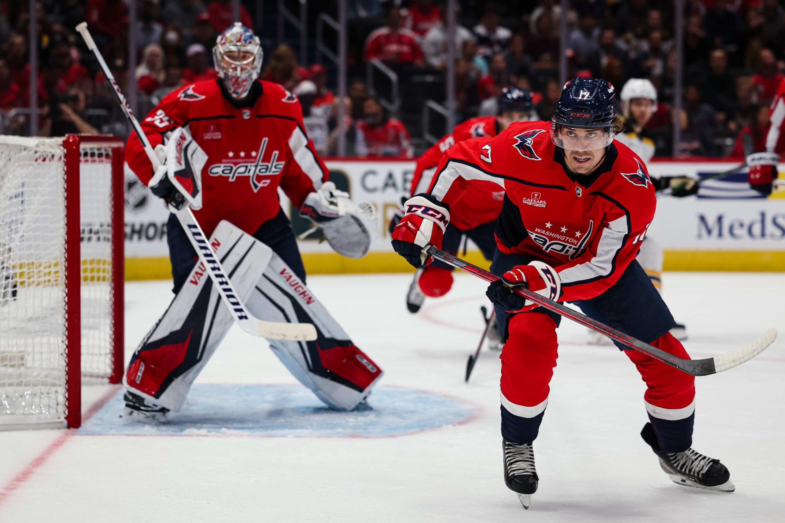 WASHINGTON, DC - OCTOBER 12: Dylan Strome #17 of the Washington Capitals skates for the puck as Darcy Kuemper #35 tends net against the Boston Bruins during the first period of the game at Capital One Arena on October 12, 2022 in Washington, DC. (Photo by Scott Taetsch/Getty Images)