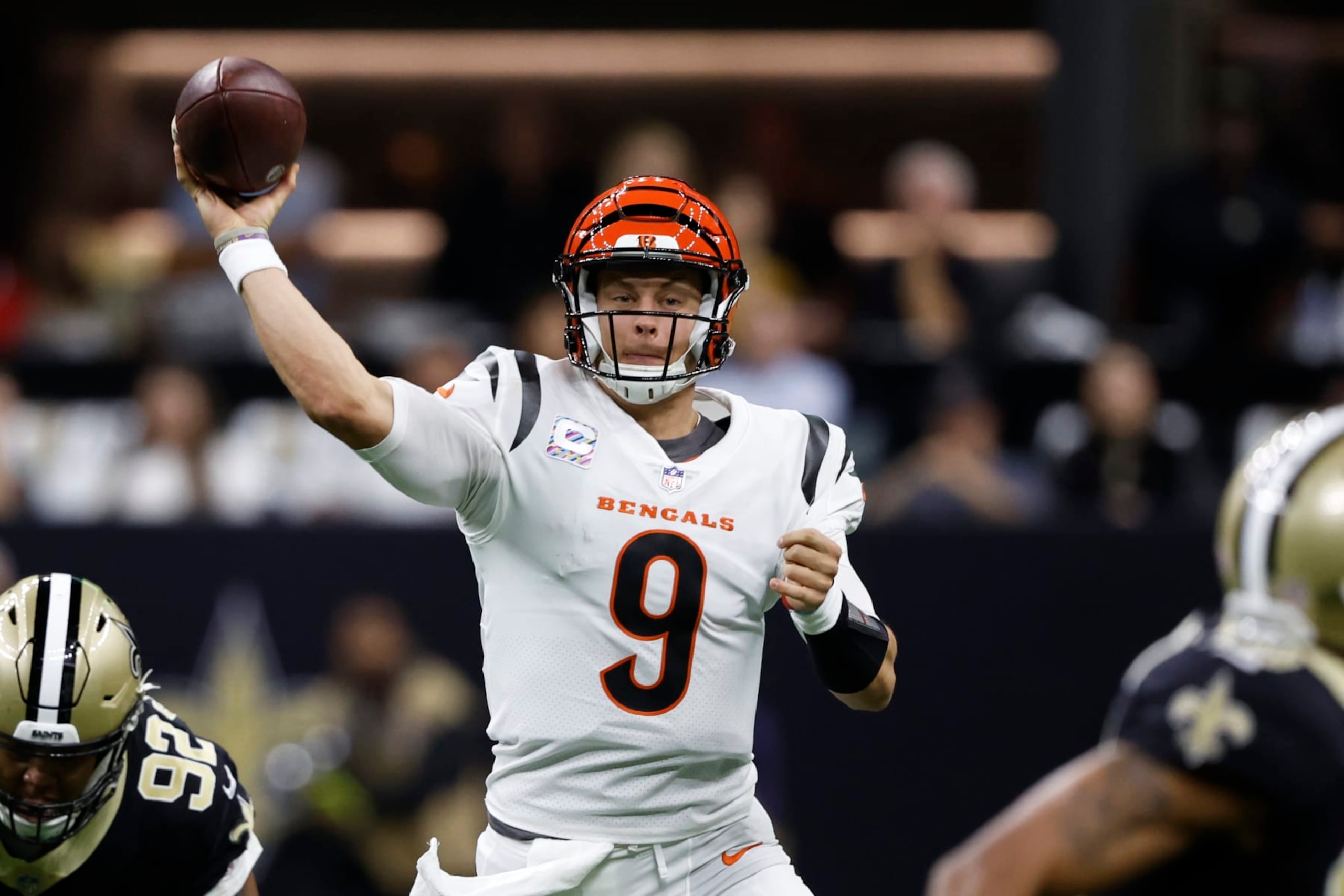 Cincinnati Bengals quarterback Joe Burrow (9) looks to pass against the New Orleans Saints during the first half of an NFL football game in New Orleans, Sunday, Oct. 16, 2022. (AP Photo/Butch Dill)