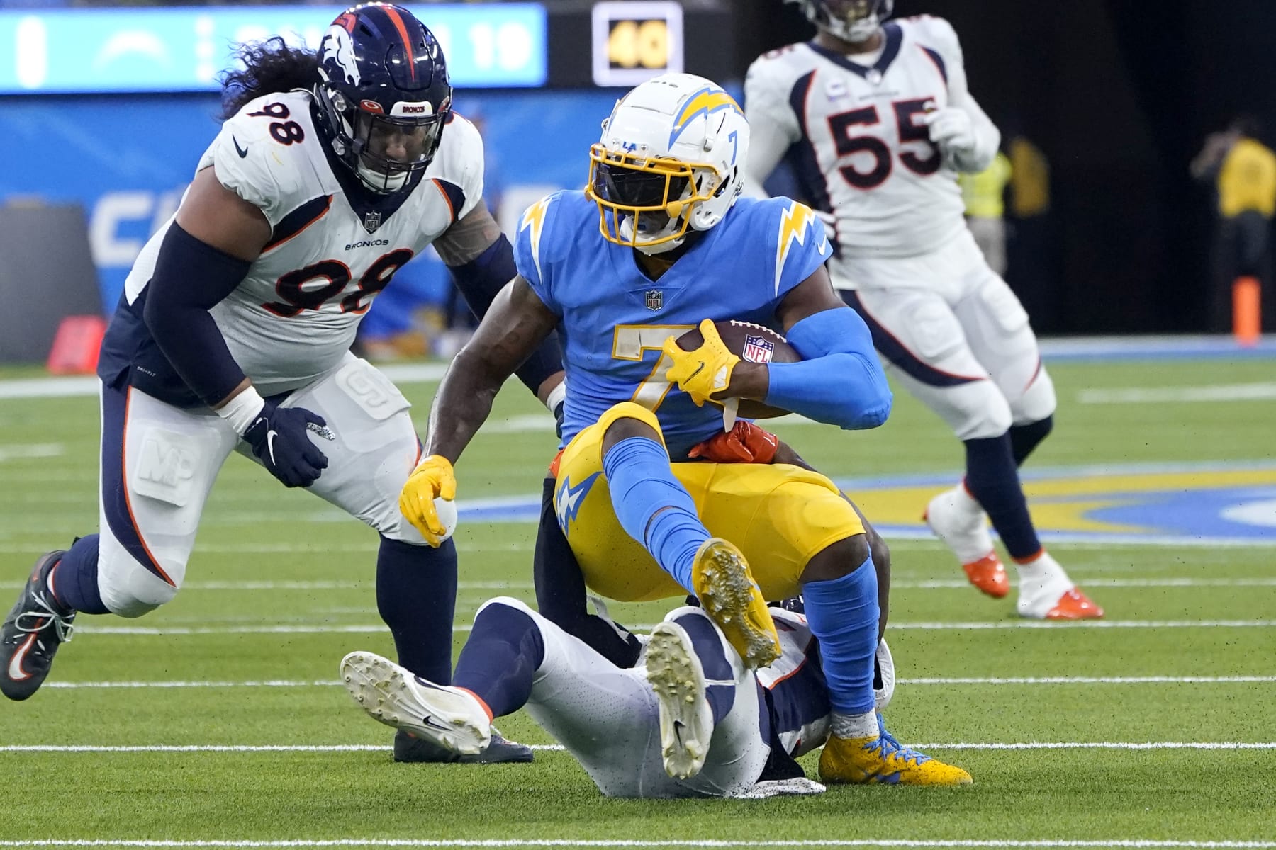Los Angeles Chargers tight end Gerald Everett (7) is tackled during the first half of an NFL football game against the Denver Broncos, Monday, Oct. 17, 2022, in Inglewood, Calif. (AP Photo/Marcio Jose Sanchez)