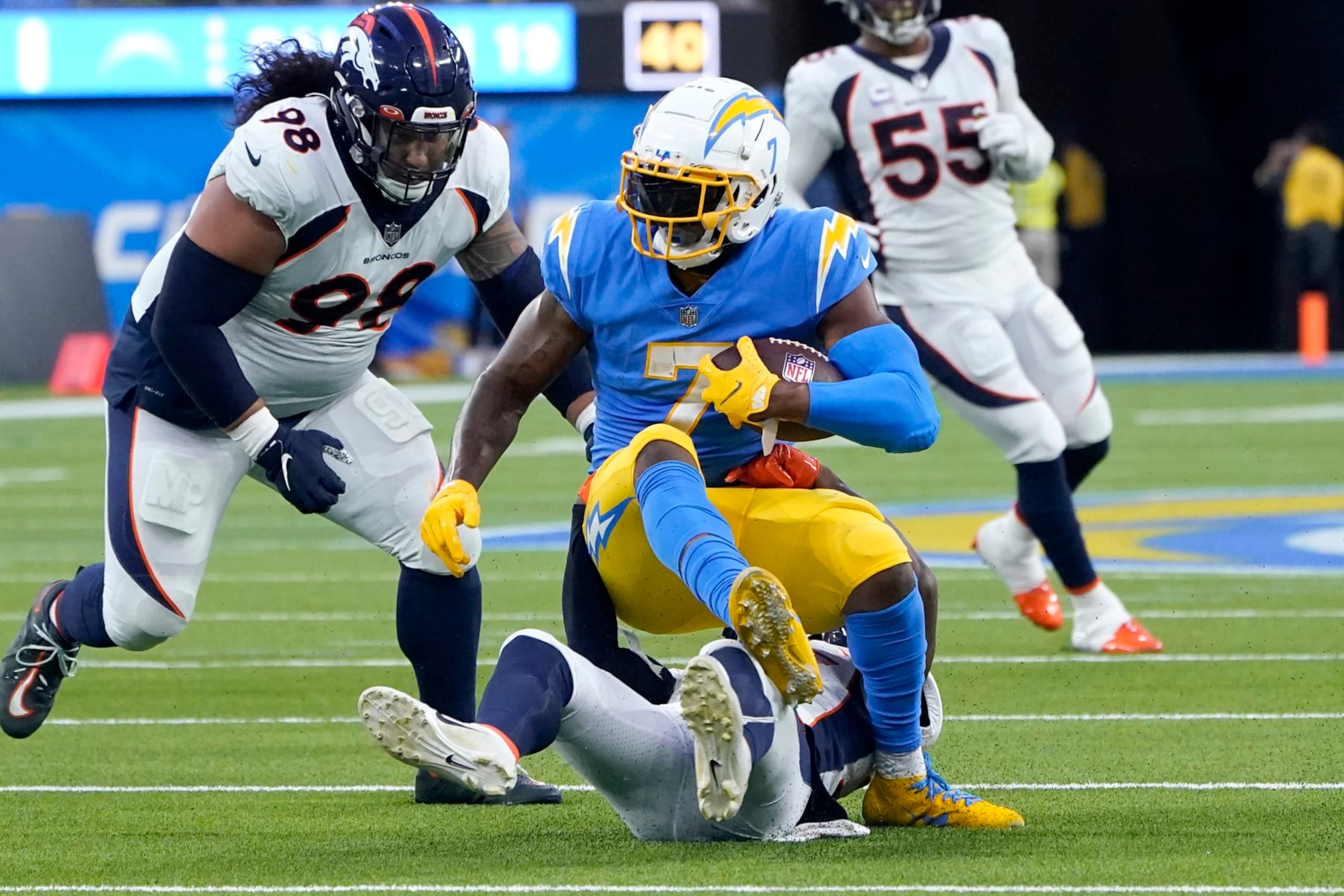 Los Angeles Chargers tight end Gerald Everett (7) is tackled during the first half of an NFL football game against the Denver Broncos, Monday, Oct. 17, 2022, in Inglewood, Calif. (AP Photo/Marcio Jose Sanchez)