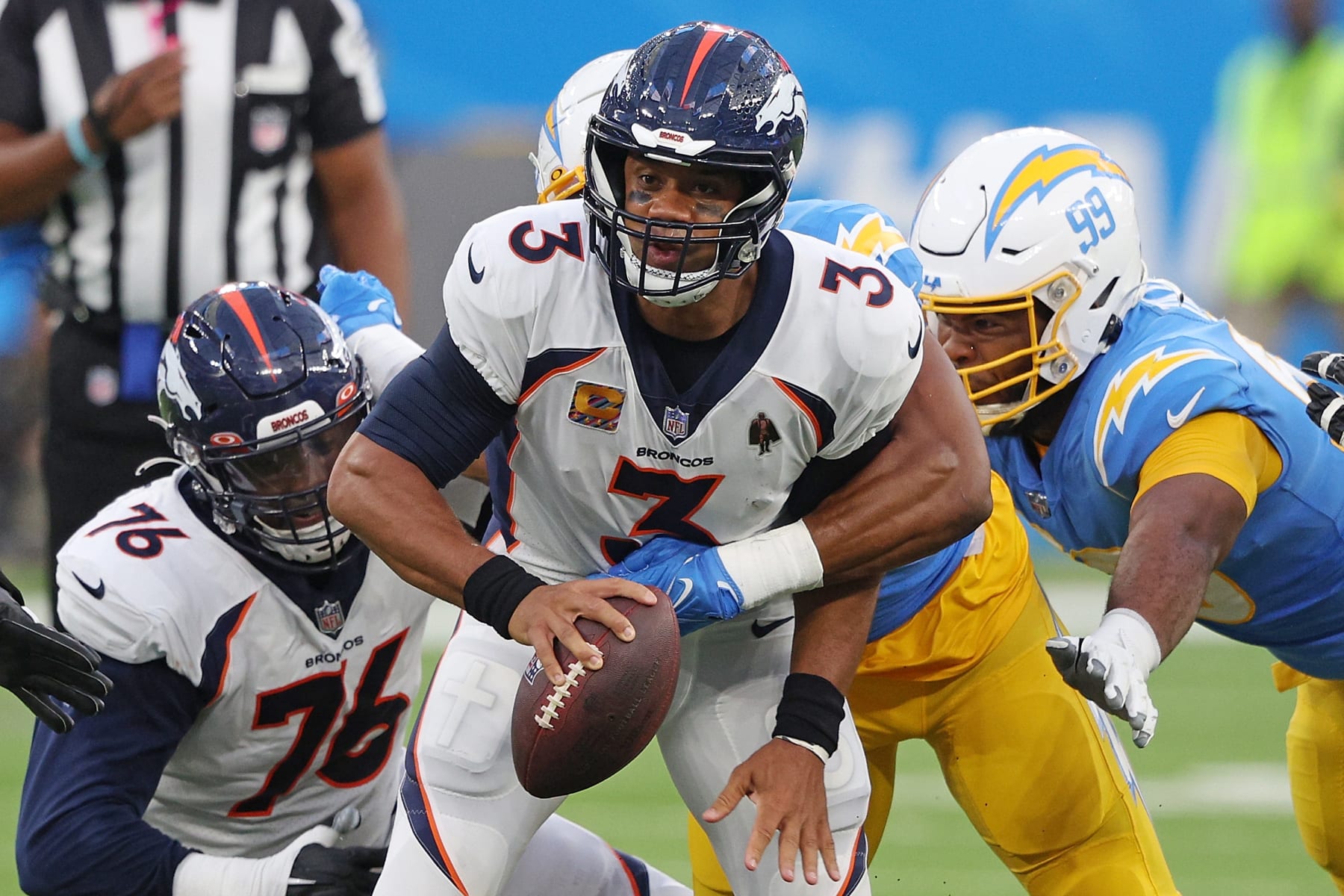 INGLEWOOD, CALIFORNIA - OCTOBER 17: Russell Wilson #3 of the Denver Broncos is sacked by Khalil Mack #52 of the Los Angeles Chargers during the first quarter at SoFi Stadium on October 17, 2022 in Inglewood, California. (Photo by Harry How/Getty Images)