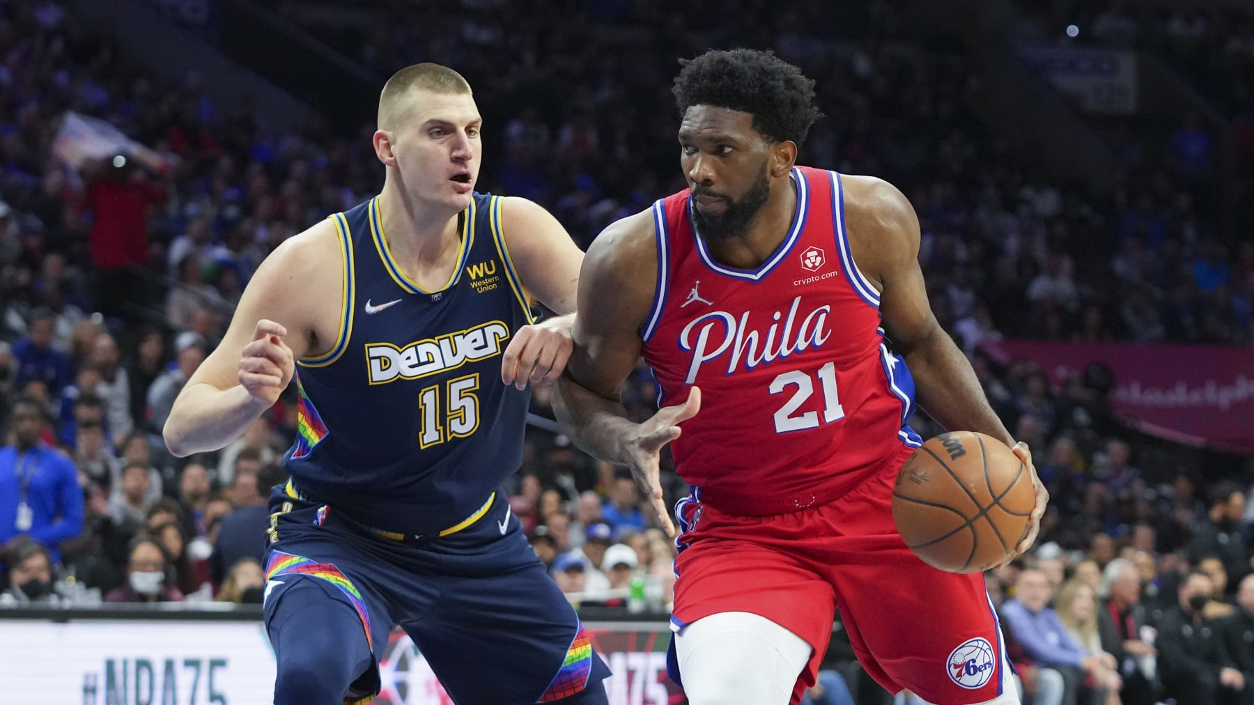 PHILADELPHIA, PA - MARCH 14: Joel Embiid #21 of the Philadelphia 76ers drives to the basket against Nikola Jokic #15 of the Denver Nuggets at the Wells Fargo Center on March 14, 2022 in Philadelphia, Pennsylvania. The Nuggets defeated the 76ers 114-110. NOTE TO USER: User expressly acknowledges and agrees that, by downloading and or using this photograph, User is consenting to the terms and conditions of the Getty Images License Agreement. (Photo by Mitchell Leff/Getty Images)