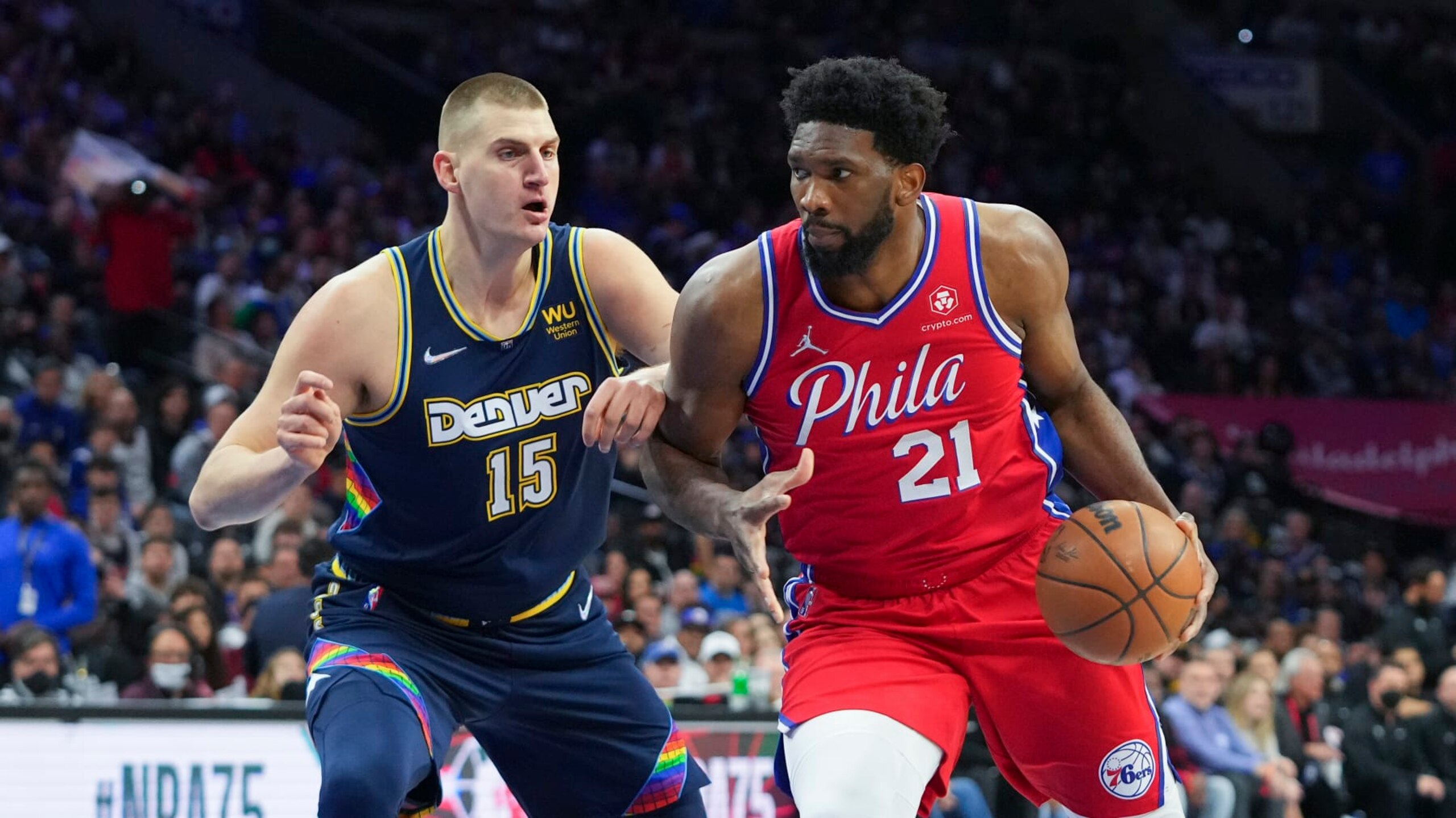 PHILADELPHIA, PA - MARCH 14: Joel Embiid #21 of the Philadelphia 76ers drives to the basket against Nikola Jokic #15 of the Denver Nuggets at the Wells Fargo Center on March 14, 2022 in Philadelphia, Pennsylvania. The Nuggets defeated the 76ers 114-110. NOTE TO USER: User expressly acknowledges and agrees that, by downloading and or using this photograph, User is consenting to the terms and conditions of the Getty Images License Agreement. (Photo by Mitchell Leff/Getty Images)