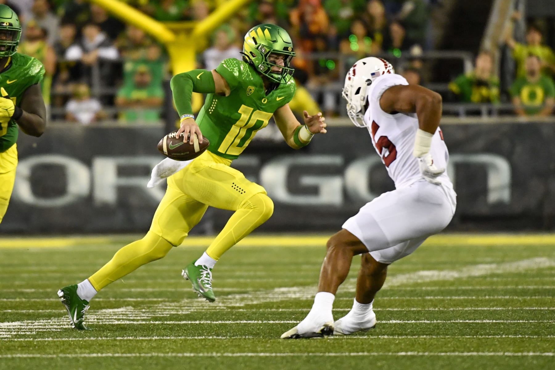 Oregon quarterback Bo Nix (10) runs the ball against Stanford during the first half of an NCAA college football game Saturday, Oct. 1, 2022, in Eugene, Ore. (AP Photo/Andy Nelson)
