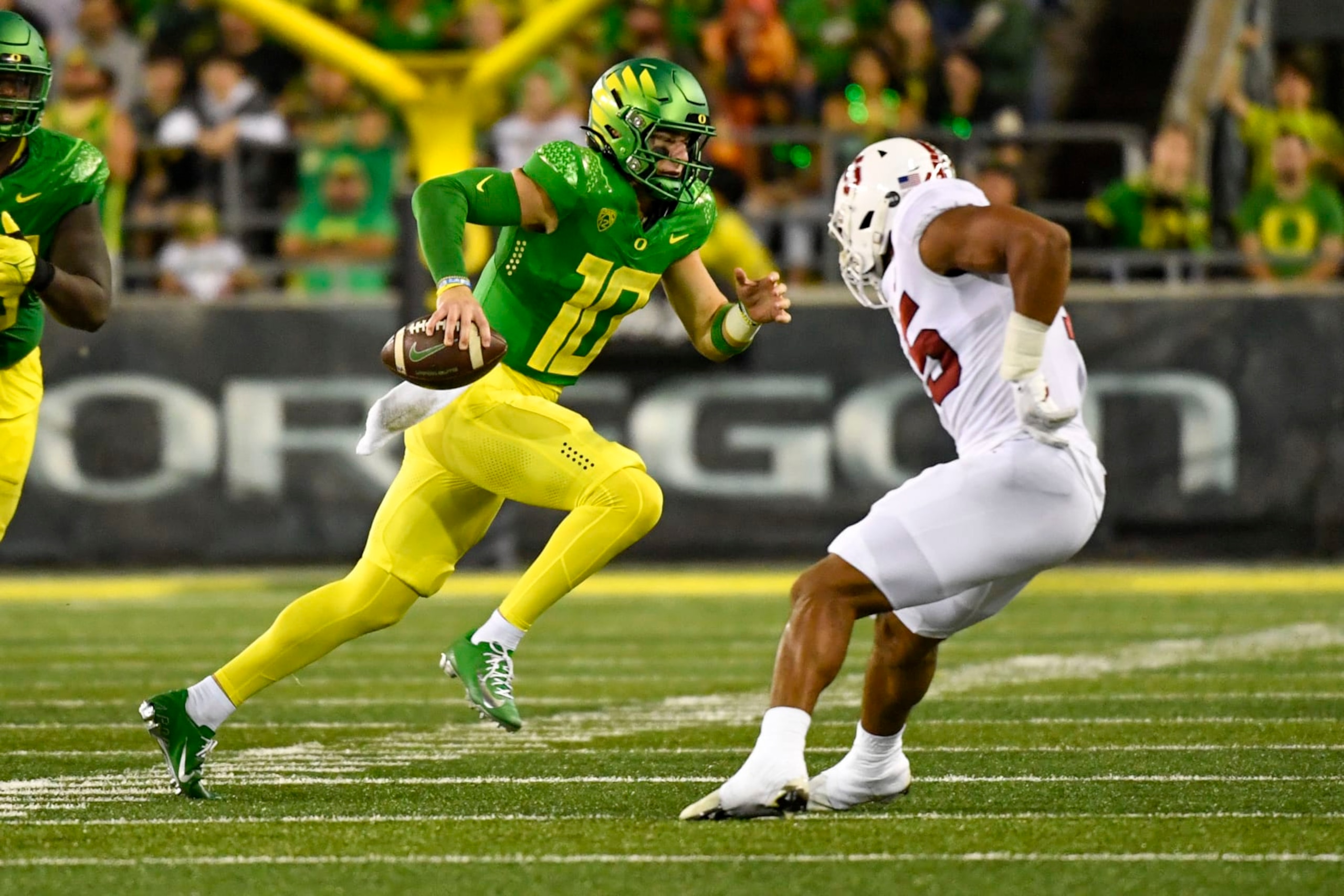 Oregon quarterback Bo Nix (10) runs the ball against Stanford during the first half of an NCAA college football game Saturday, Oct. 1, 2022, in Eugene, Ore. (AP Photo/Andy Nelson)