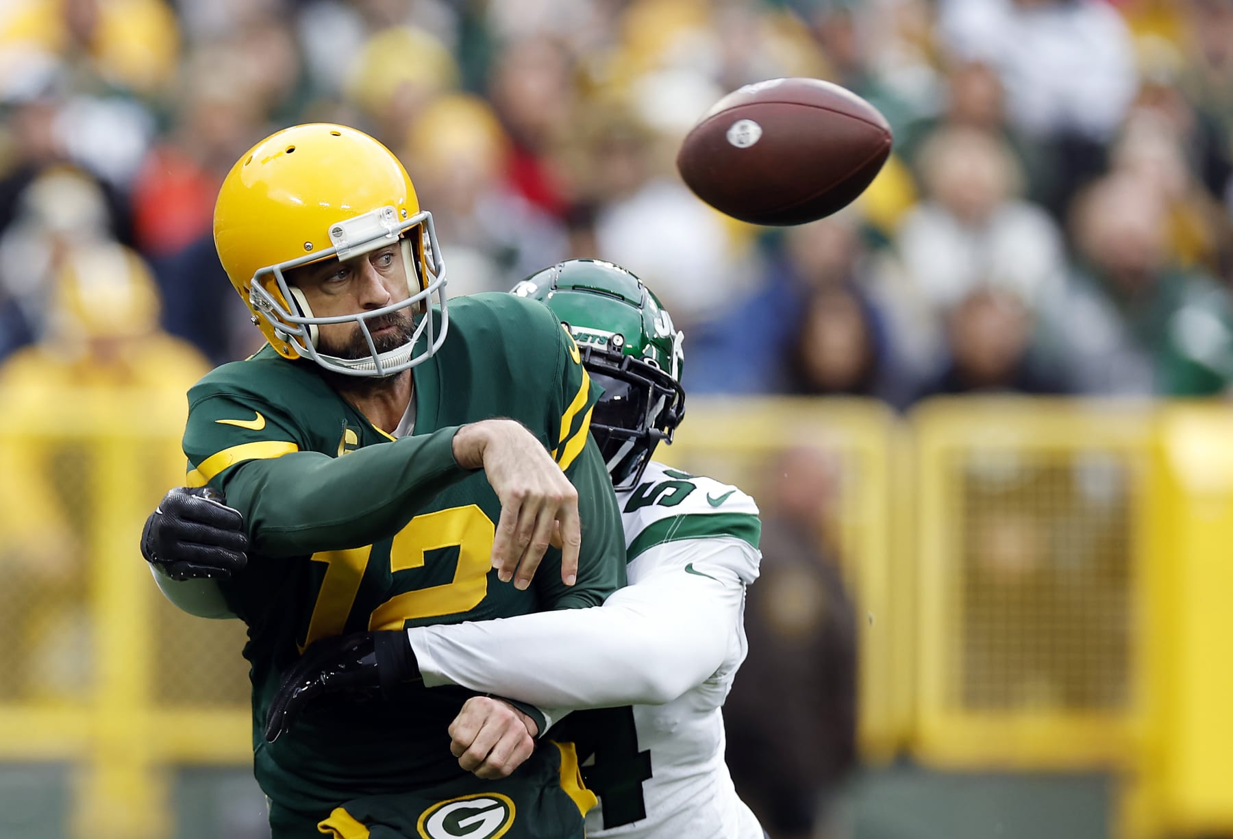 GREEN BAY, WISCONSIN - OCTOBER 16: Aaron Rodgers #12 of the Green Bay Packers while throwing a pass during the first quarter a game against the New York Jets at Lambeau Field on October 16, 2022 in Green Bay, Wisconsin. (Photo by John Fisher/Getty Images)