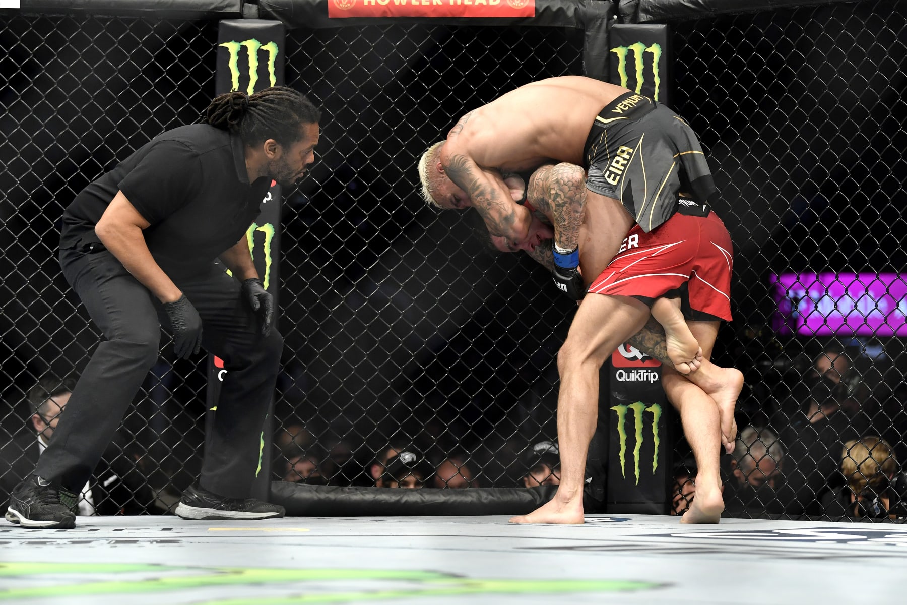 LAS VEGAS, NEVADA - DECEMBER 11: Charles Oliveira of Brazil jumps onto Dustin Poirier's back during their UFC lightweight championship bout during the UFC 269 on December 11, 2021 in Las Vegas, Nevada. (Photo by Chris Unger/Zuffa LLC)