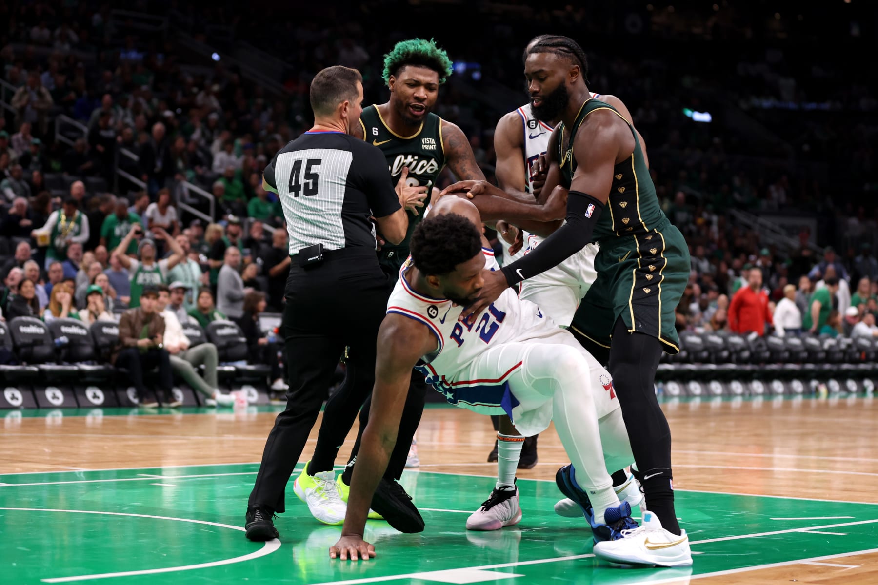 BOSTON, MASSACHUSETTS - OCTOBER 18: Marcus Smart #36 of the Boston Celtics and Joel Embiid #21 of the Philadelphia 76ers are separated by referee Brian Forte #45 during the second half at TD Garden on October 18, 2022 in Boston, Massachusetts. NOTE TO USER: User expressly acknowledges and agrees that, by downloading and or using this photograph, User is consenting to the terms and conditions of the Getty Images License Agreement. (Photo by Maddie Meyer/Getty Images)
