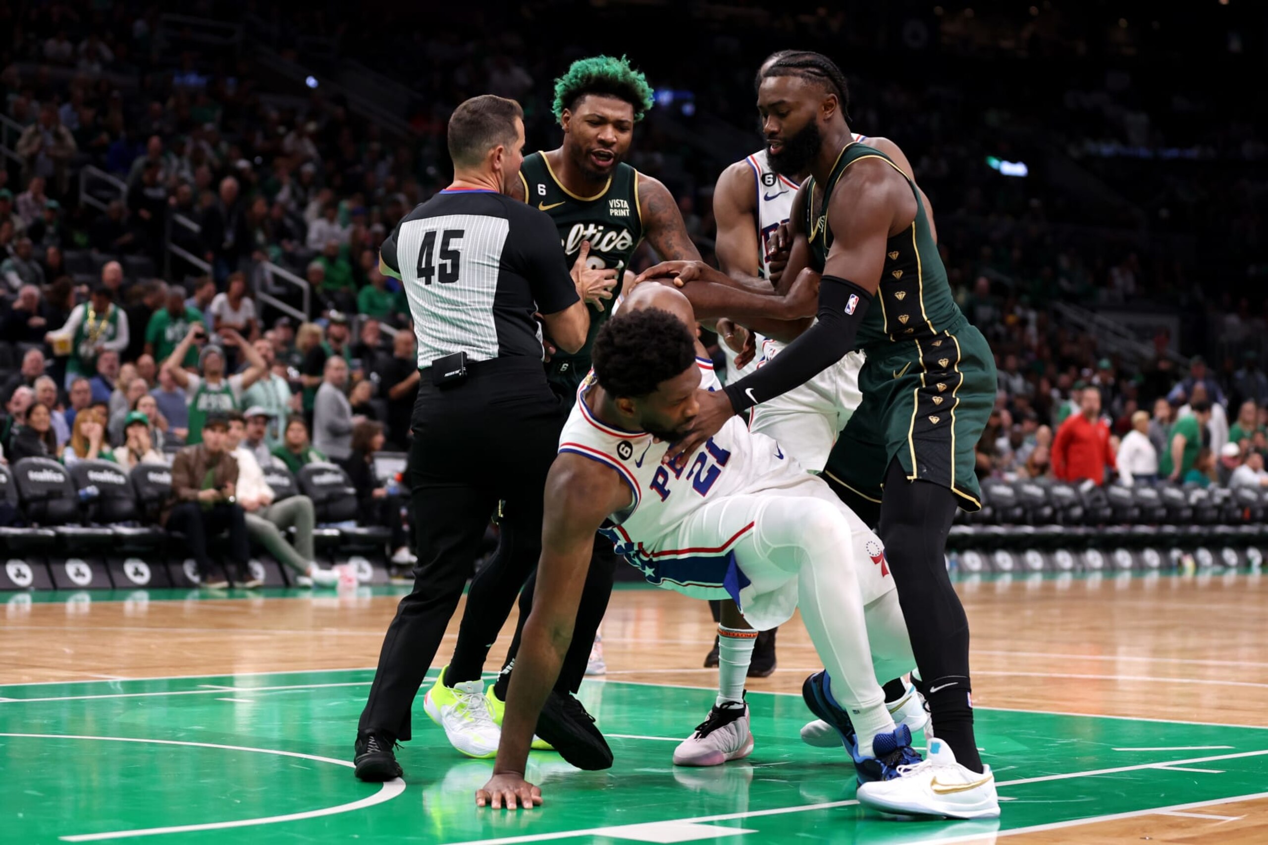 BOSTON, MASSACHUSETTS - OCTOBER 18: Marcus Smart #36 of the Boston Celtics and Joel Embiid #21 of the Philadelphia 76ers are separated by referee Brian Forte #45 during the second half at TD Garden on October 18, 2022 in Boston, Massachusetts. NOTE TO USER: User expressly acknowledges and agrees that, by downloading and or using this photograph, User is consenting to the terms and conditions of the Getty Images License Agreement. (Photo by Maddie Meyer/Getty Images)