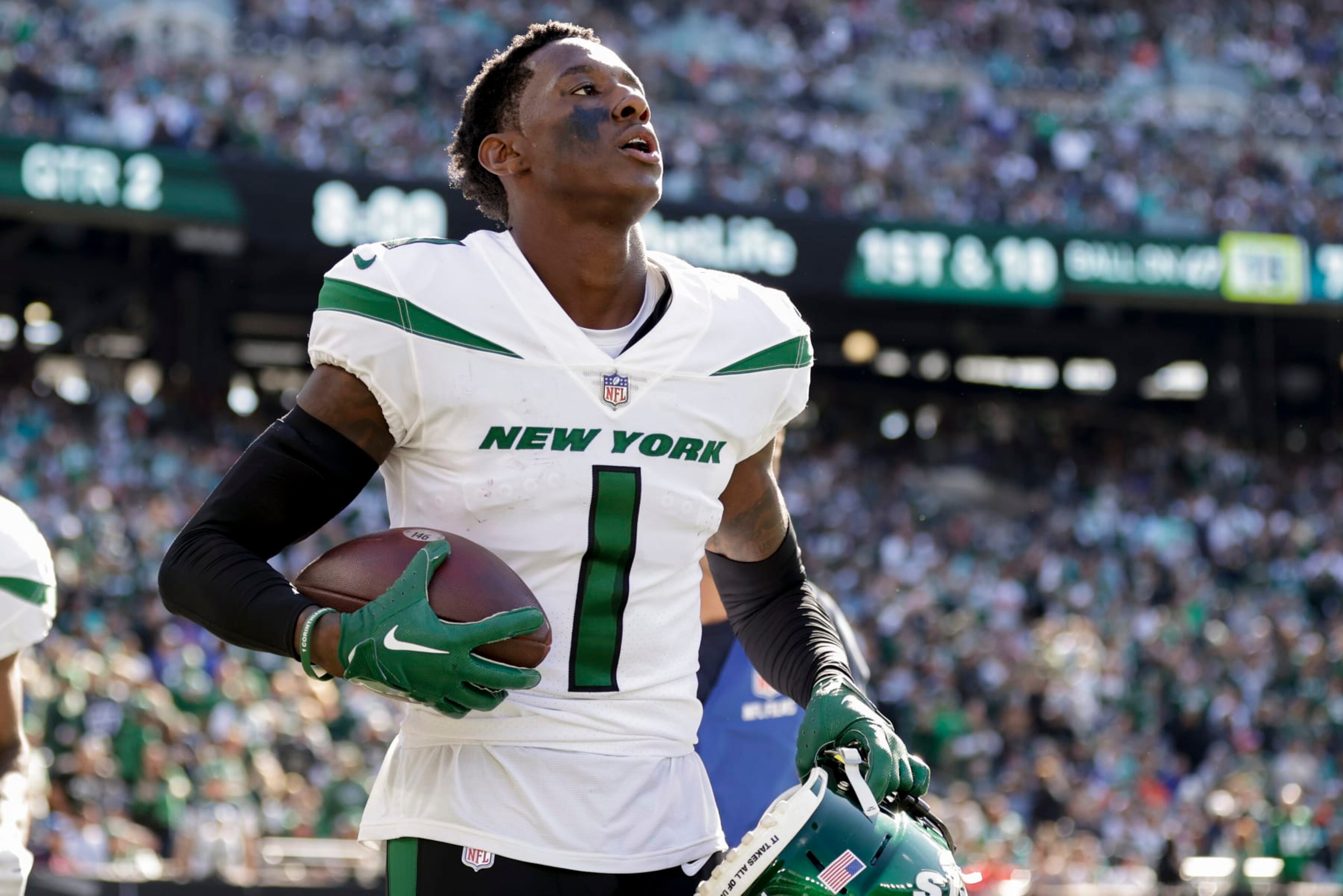 New York Jets cornerback Sauce Gardner (1) carries a game ball to the sidelines after intercepting a pass against the Miami Dolphins during the second quarter of an NFL football game, Sunday, Oct. 9, 2022, in East Rutherford, N.J. (AP Photo/Adam Hunger)