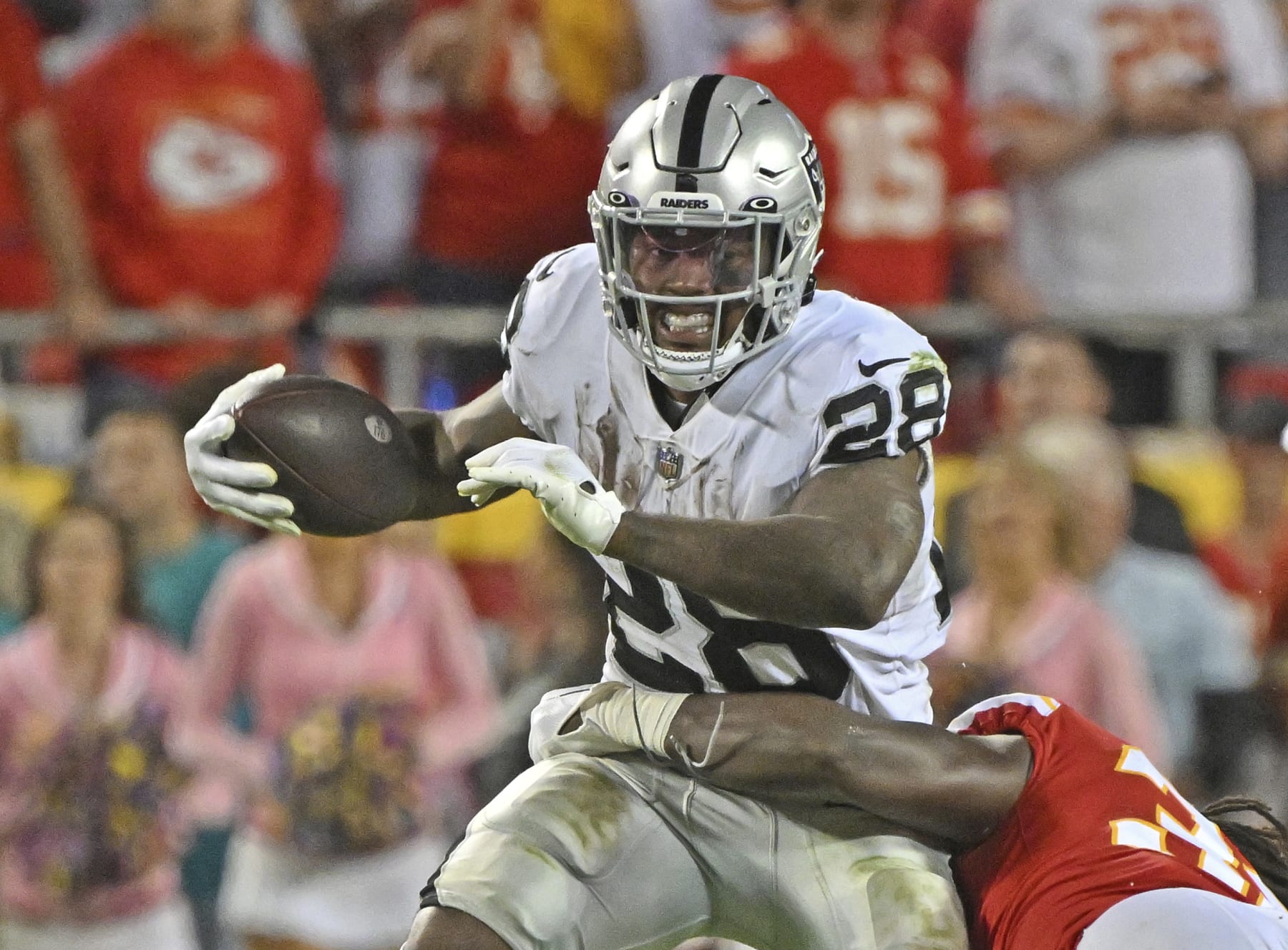 Las Vegas Raiders running back Josh Jacobs (28) runs with the ball during an NFL football game against the Kansas City Chiefs Monday, Oct. 10, 2022, in Kansas City, Mo. (AP Photo/Peter Aiken)