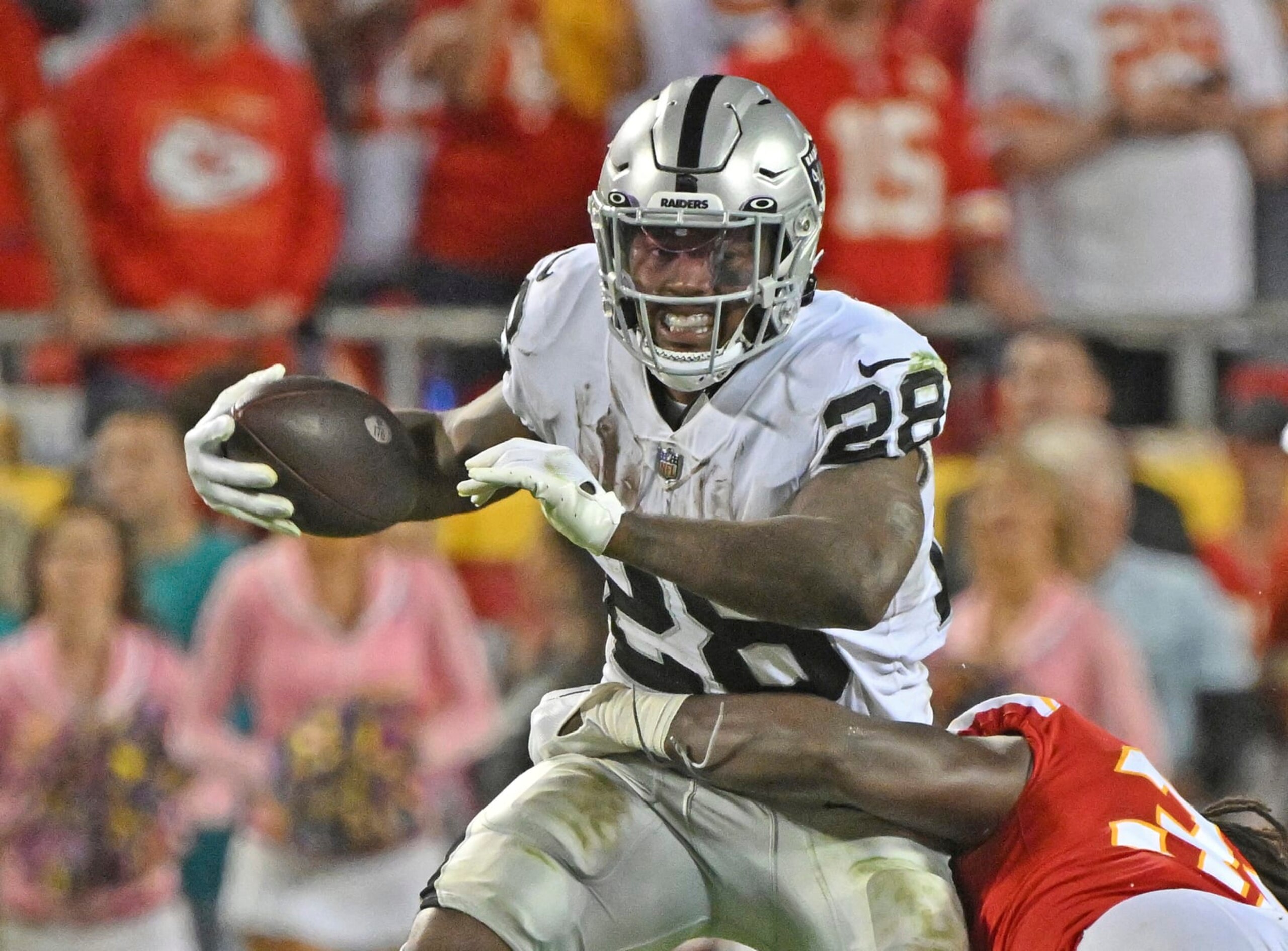 Las Vegas Raiders running back Josh Jacobs (28) runs with the ball during an NFL football game against the Kansas City Chiefs Monday, Oct. 10, 2022, in Kansas City, Mo. (AP Photo/Peter Aiken)
