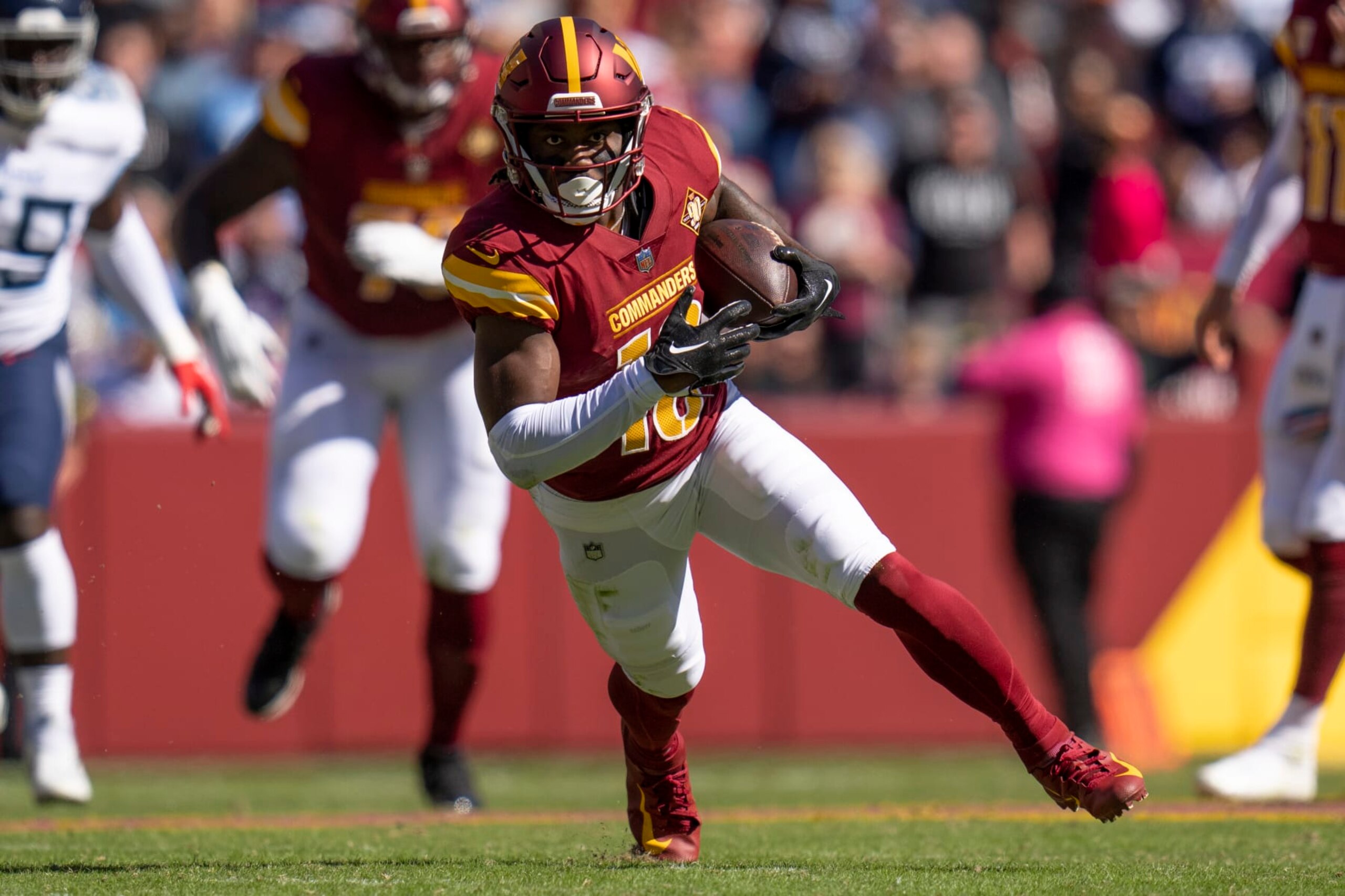 Washington Commanders wide receiver Curtis Samuel (10) runs with the ball during the first half of an NFL football game against the Tennessee Titans, Sunday, Oct. 9, 2022, in Landover, Md. The Titans won 21-17. (AP Photo/Jess Rapfogel)