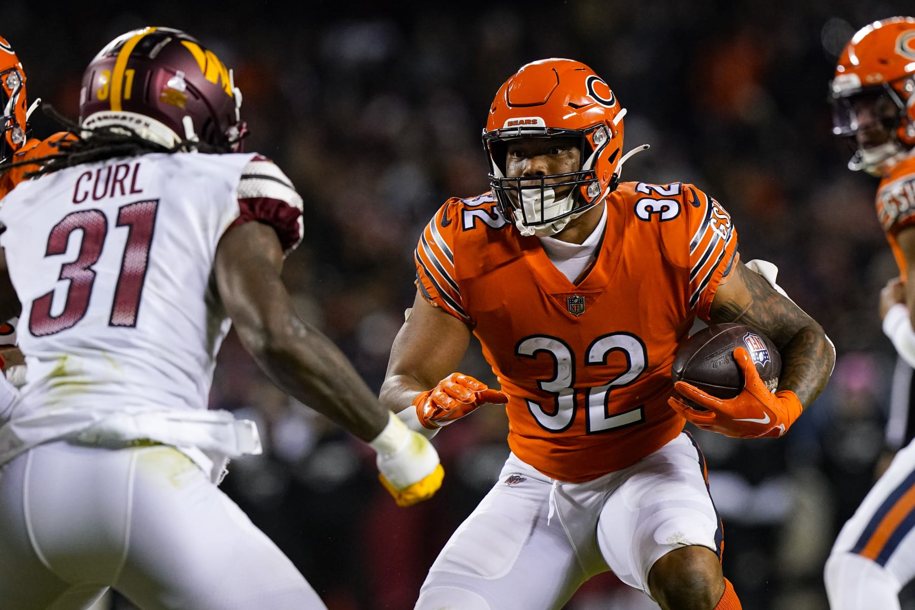 Chicago Bears running back David Montgomery cuts away from Washington Commanders safety Kam Curl in the first half of an NFL football game in Chicago, Thursday, Oct. 13, 2022. (AP Photo/Nam Y. Huh)