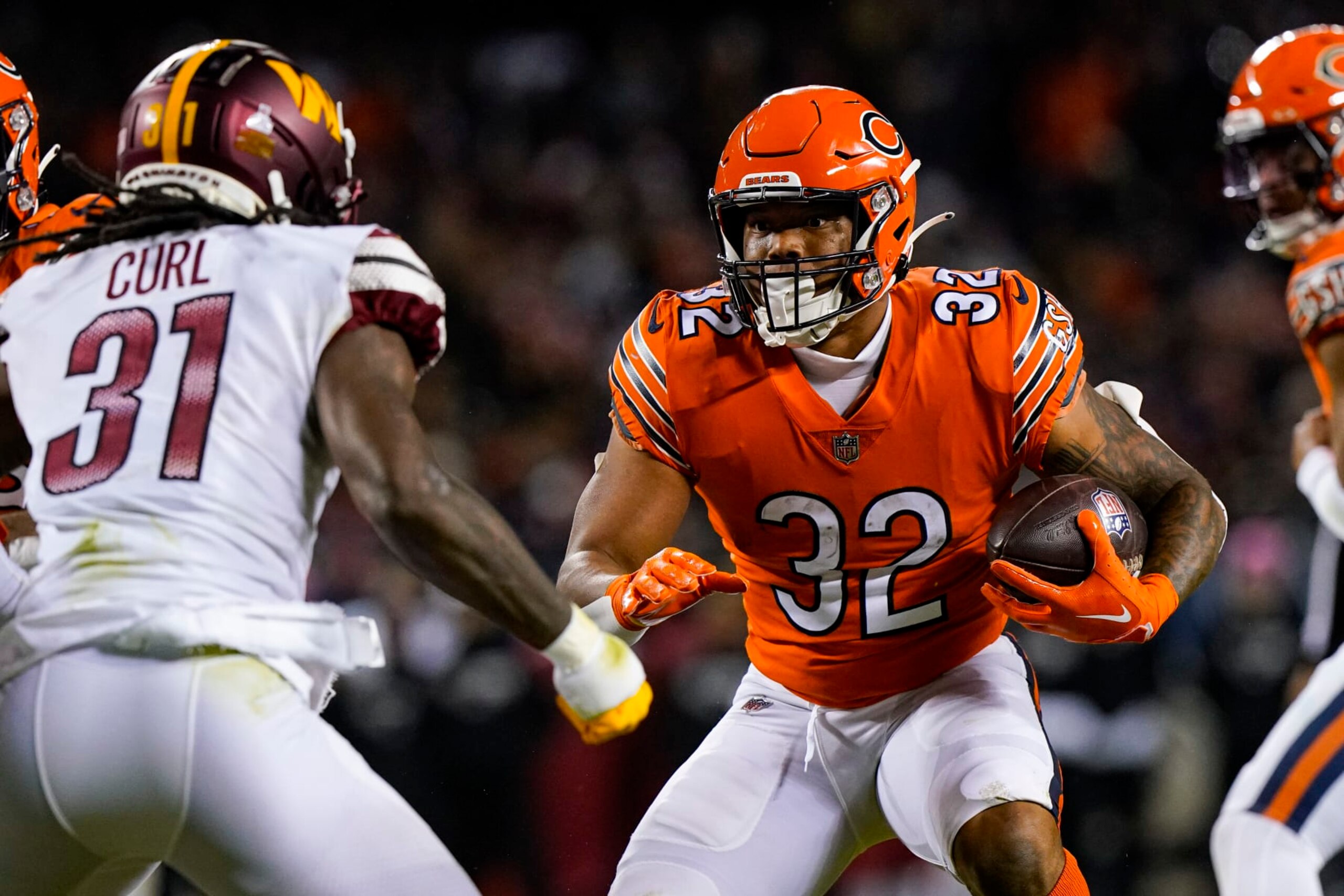 Chicago Bears running back David Montgomery cuts away from Washington Commanders safety Kam Curl in the first half of an NFL football game in Chicago, Thursday, Oct. 13, 2022. (AP Photo/Nam Y. Huh)