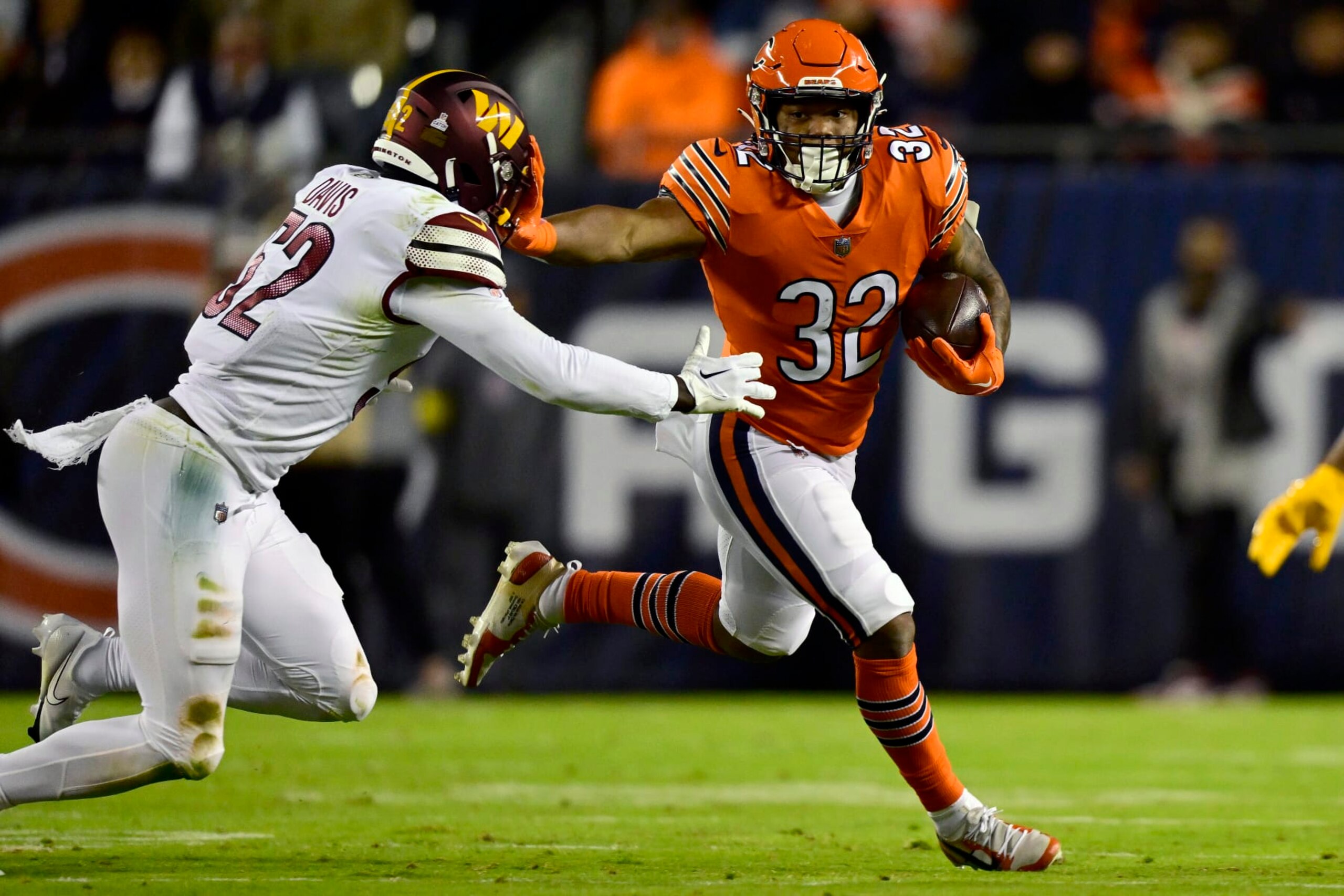 CHICAGO, ILLINOIS - OCTOBER 13: David Montgomery #32 of the Chicago Bears carries the ball during the first quarter against Jamin Davis #52 of the Washington Commanders at Soldier Field on October 13, 2022 in Chicago, Illinois. (Photo by Quinn Harris/Getty Images)