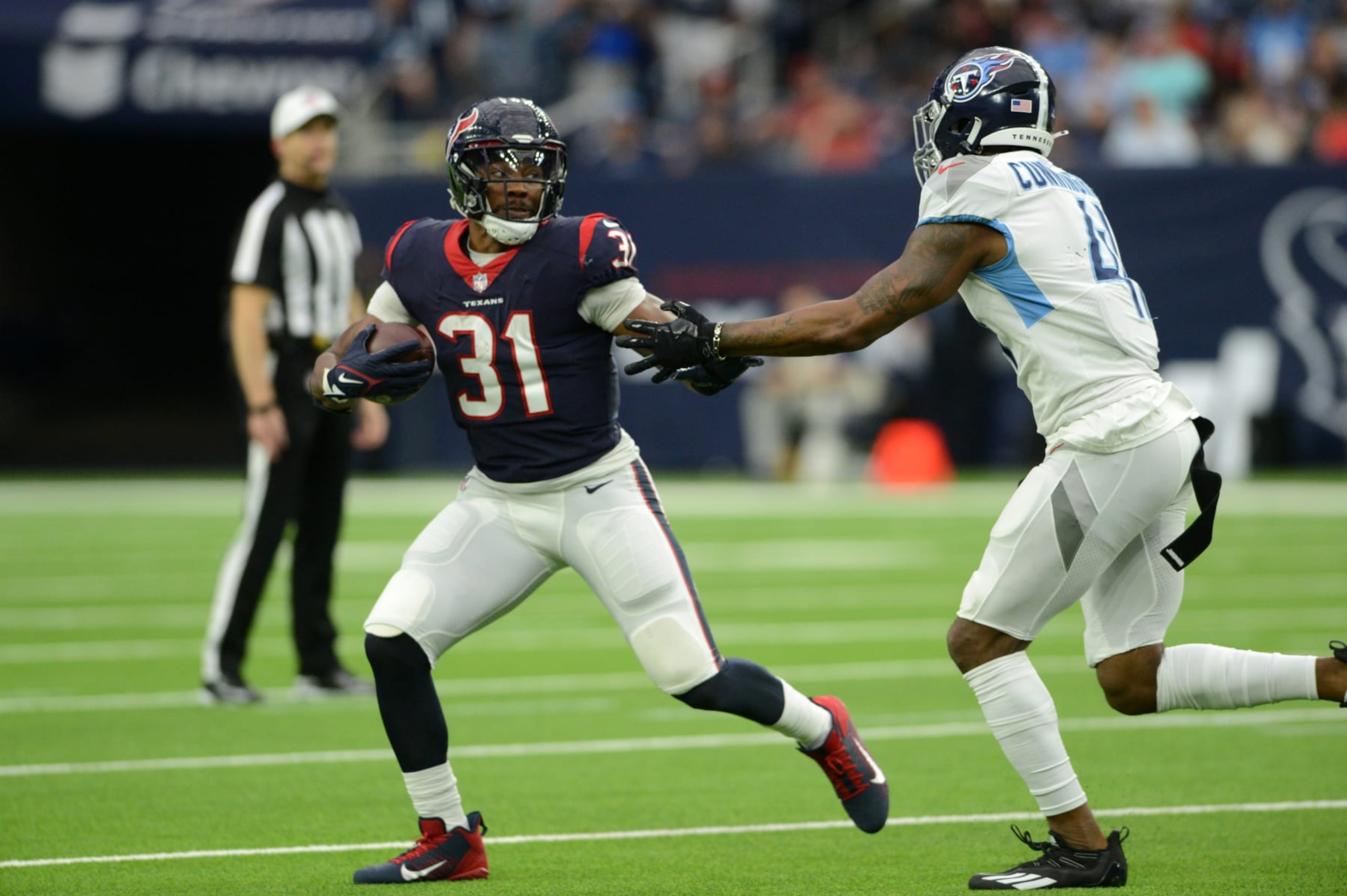 HOUSTON, TX - JANUARY 09: Houston Texans RB David Johnson (31) is chased by Tennessee Titans LB Zach Cunningham during game featuring the Houston Texans and the Tennessee Titans on January 9, 2022 at NRG Stadium in Houston, TX. (Photo by John Rivera/Icon Sportswire via Getty Images)