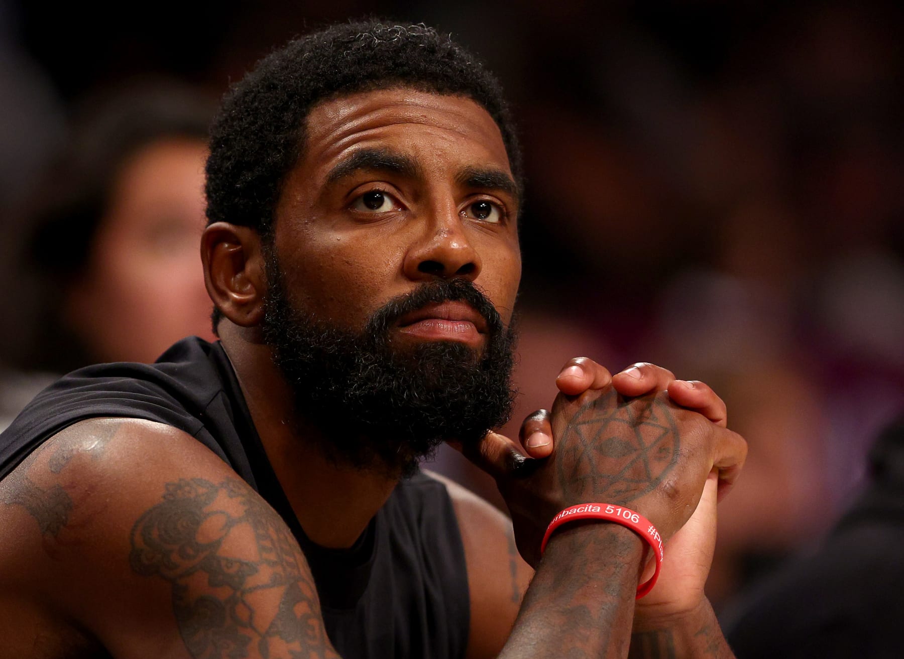 NEW YORK, NEW YORK - OCTOBER 03:  Kyrie Irving #11 of the Brooklyn Nets looks on from the bench in the second half against the Philadelphia 76ers during a preseason game at Barclays Center on October 03, 2022 in the Brooklyn borough of New York City. The Philadelphia 76ers defeated the Brooklyn Nets 127-108. NOTE TO USER: User expressly acknowledges and agrees that, by downloading and or using this photograph, User is consenting to the terms and conditions of the Getty Images License Agreement. (Photo by Elsa/Getty Images)