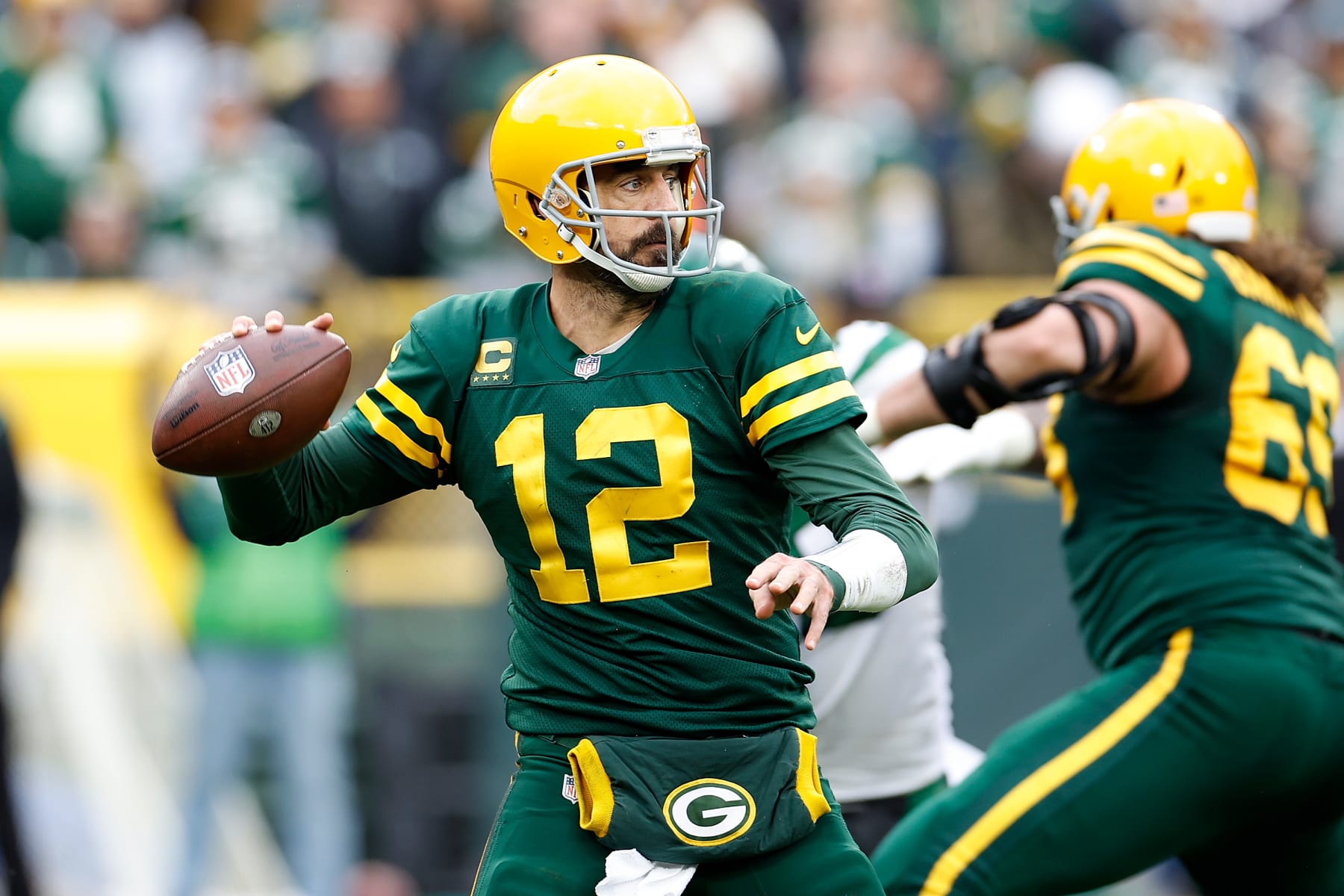 GREEN BAY, WISCONSIN - OCTOBER 16: Aaron Rodgers #12 of the Green Bay Packers drops back to pass against the New York Jets at Lambeau Field on October 16, 2022 in Green Bay, Wisconsin. Jets defeated the Packers 27-10. (Photo by John Fisher/Getty Images)