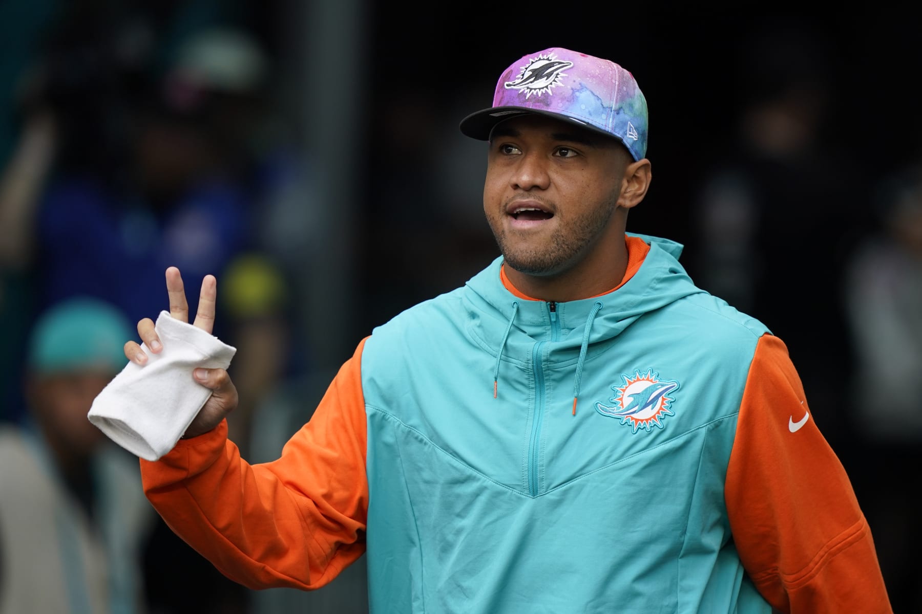 Miami Dolphins quarterback Tua Tagovailoa (1) walks onto the field, not dressed to play, ahead of an NFL football game against the Minnesota Vikings, Sunday, Oct. 16, 2022, in Miami Gardens, Fla. (AP Photo/Wilfredo Lee)