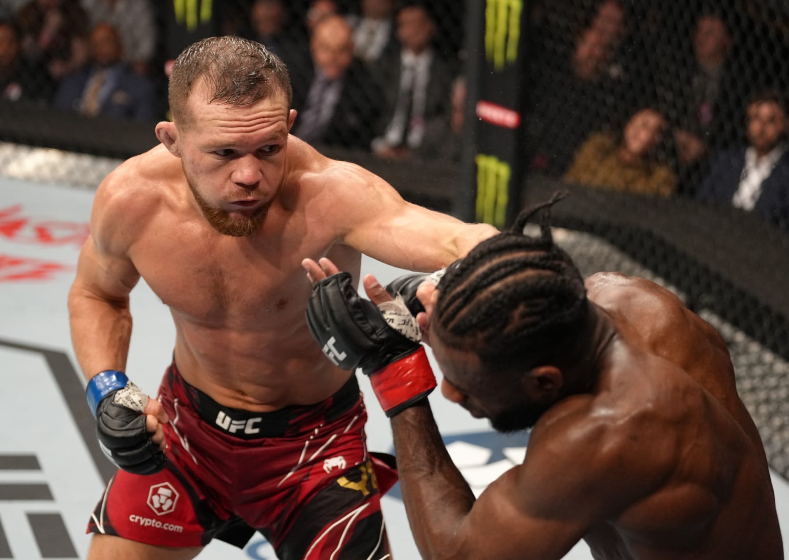 JACKSONVILLE, FLORIDA - APRIL 09: (L-R) Petr Yan of Russia punches Aljamain Sterling in their UFC bantamweight championship fight during the UFC 273 event at VyStar Veterans Memorial Arena on April 09, 2022 in Jacksonville, Florida. (Photo by Jeff Bottari/Zuffa LLC)