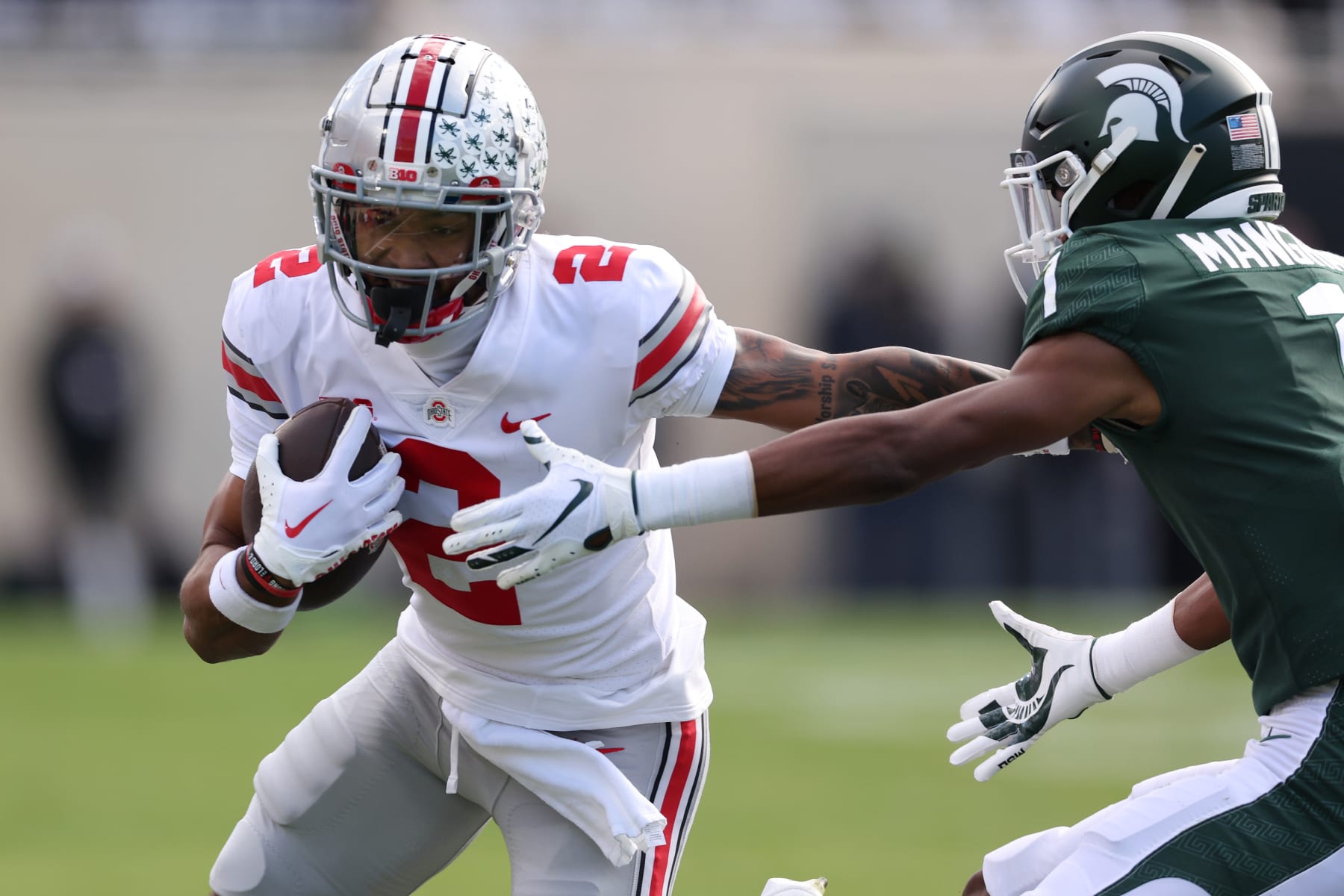 EAST LANSING, MICHIGAN - OCTOBER 08: Emeka Egbuka #2 of the Ohio State Buckeyes battles for yards after a first half catch against Jaden Mangham #1 of the Michigan State Spartans at Spartan Stadium on October 08, 2022 in East Lansing, Michigan. (Photo by Gregory Shamus/Getty Images)