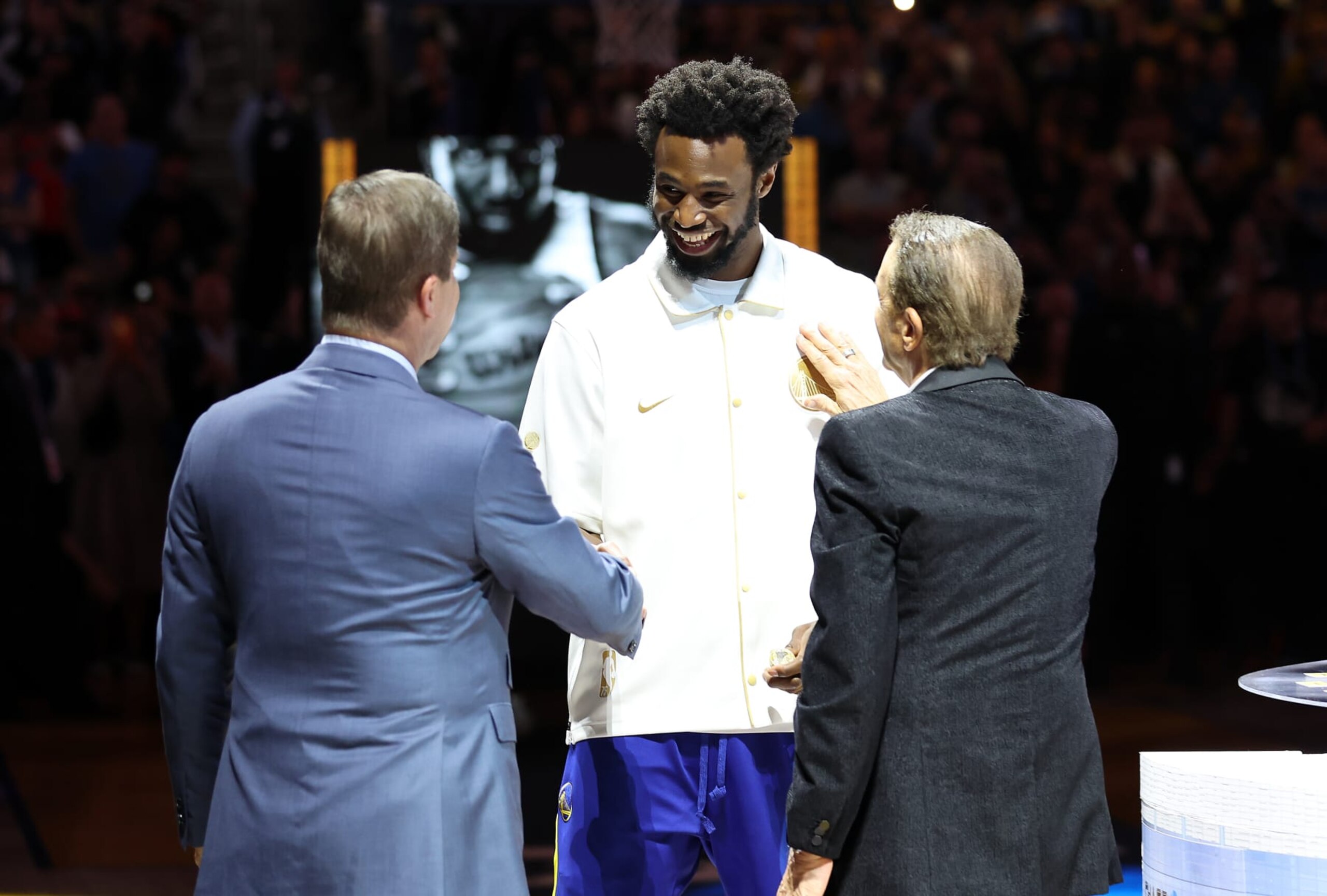 SAN FRANCISCO, CALIFORNIA - OCTOBER 18: Andrew Wiggins #22 of the Golden State Warriors receives his Championship ring from team owners Joe Lacob and Peter Guber during a ceremony prior to the game against the Los Angeles Lakers at Chase Center on October 18, 2022 in San Francisco, California. NOTE TO USER: User expressly acknowledges and agrees that, by downloading and or using this photograph, User is consenting to the terms and conditions of the Getty Images License Agreement. (Photo by Ezra Shaw/Getty Images) SAN FRANCISCO, CALIFORNIA - OCTOBER 18: Andrew Wiggins #22 of the Golden State Warriors receives his Championship ring from team owners Joe Lacob and Peter Guber during a ceremony prior to the game against the Los Angeles Lakers at Chase Center on October 18, 2022 in San Francisco, California. NOTE TO USER: User expressly acknowledges and agrees that, by downloading and or using this photograph, User is consenting to the terms and conditions of the Getty Images License Agreement. (Photo by Ezra Shaw/Getty Images)