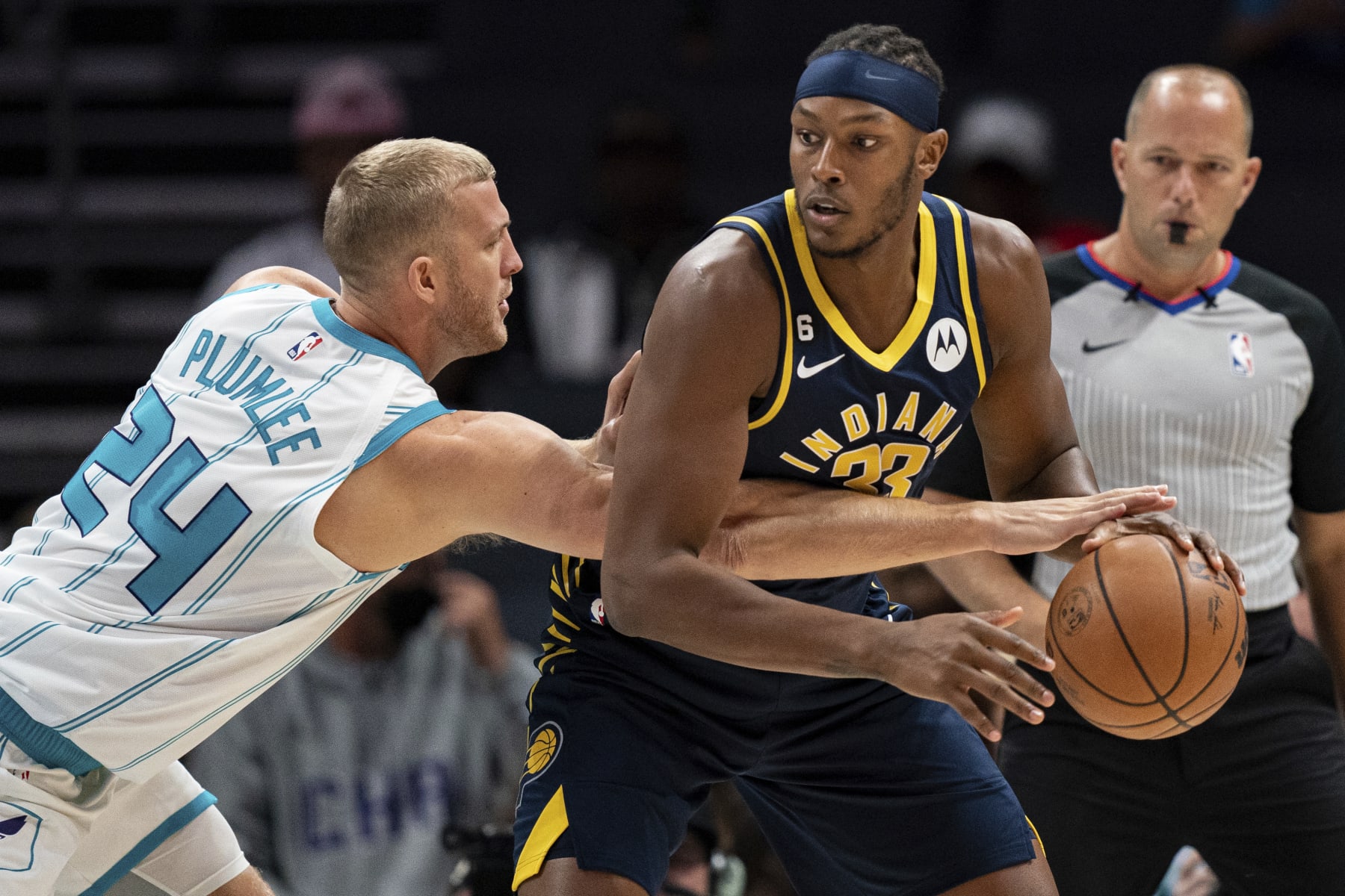Charlotte Hornets center Mason Plumlee (24) tries to knock the ball away from Indiana Pacers center Myles Turner (33) during the first half of an NBA preseason basketball game in Charlotte, N.C., Wednesday, Oct. 5, 2022. (AP Photo/Jacob Kupferman)