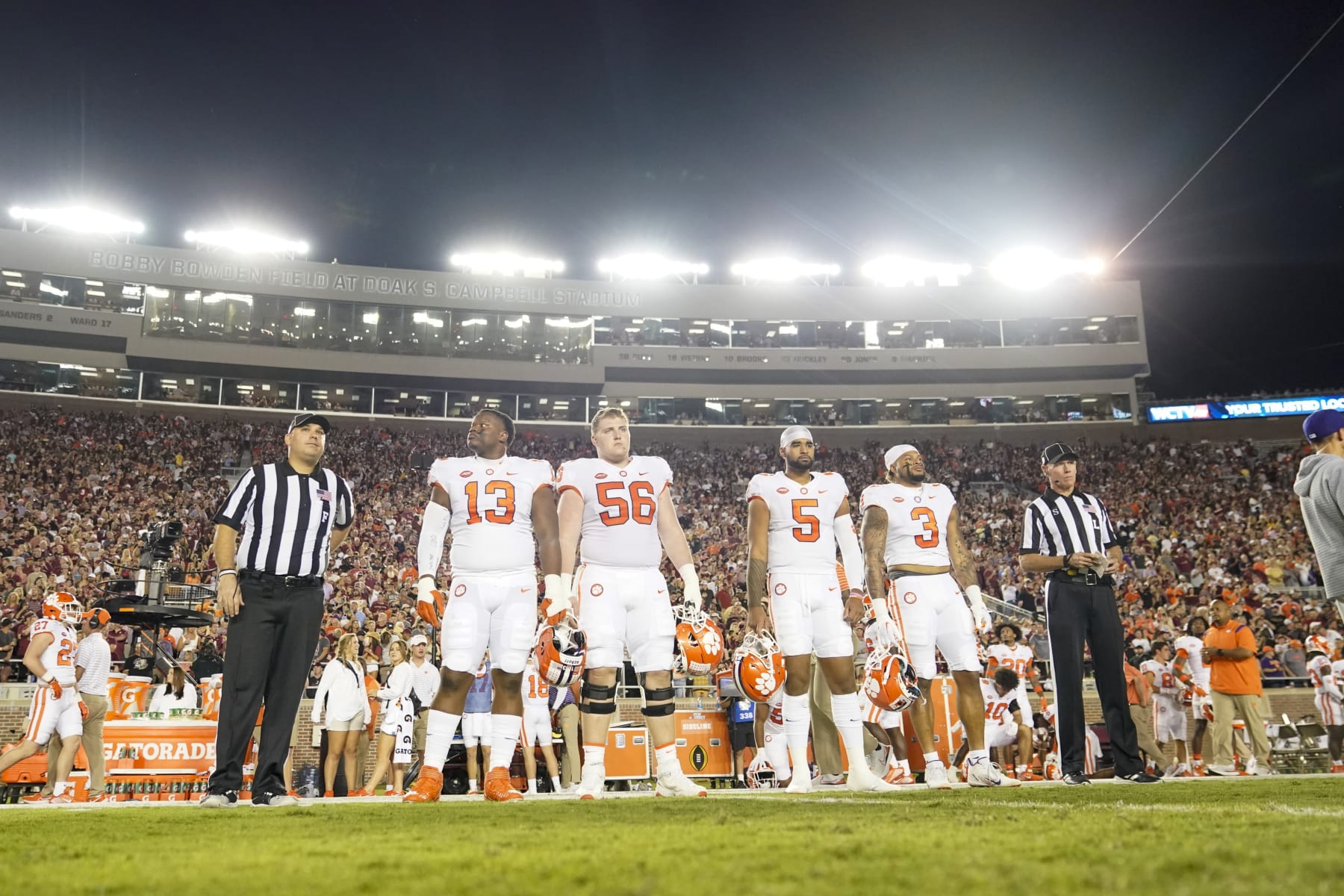 TALLAHASSEE, FL - OCTOBER 15: Clemson Tigers captains Clemson Tigers defensive tackle Tyler Davis (13), Clemson Tigers offensive lineman Will Putnam (56), Clemson Tigers quarterback DJ Uiagalelei (5)] and Clemson Tigers defensive end Xavier Thomas (3) line up before the Clemson Tigers game against the Florida State Seminoles on October 15, 2022, at Doak Campbell Stadium in Tallahassee, FL. (Photo by Chris Leduc/Icon Sportswire via Getty Images)