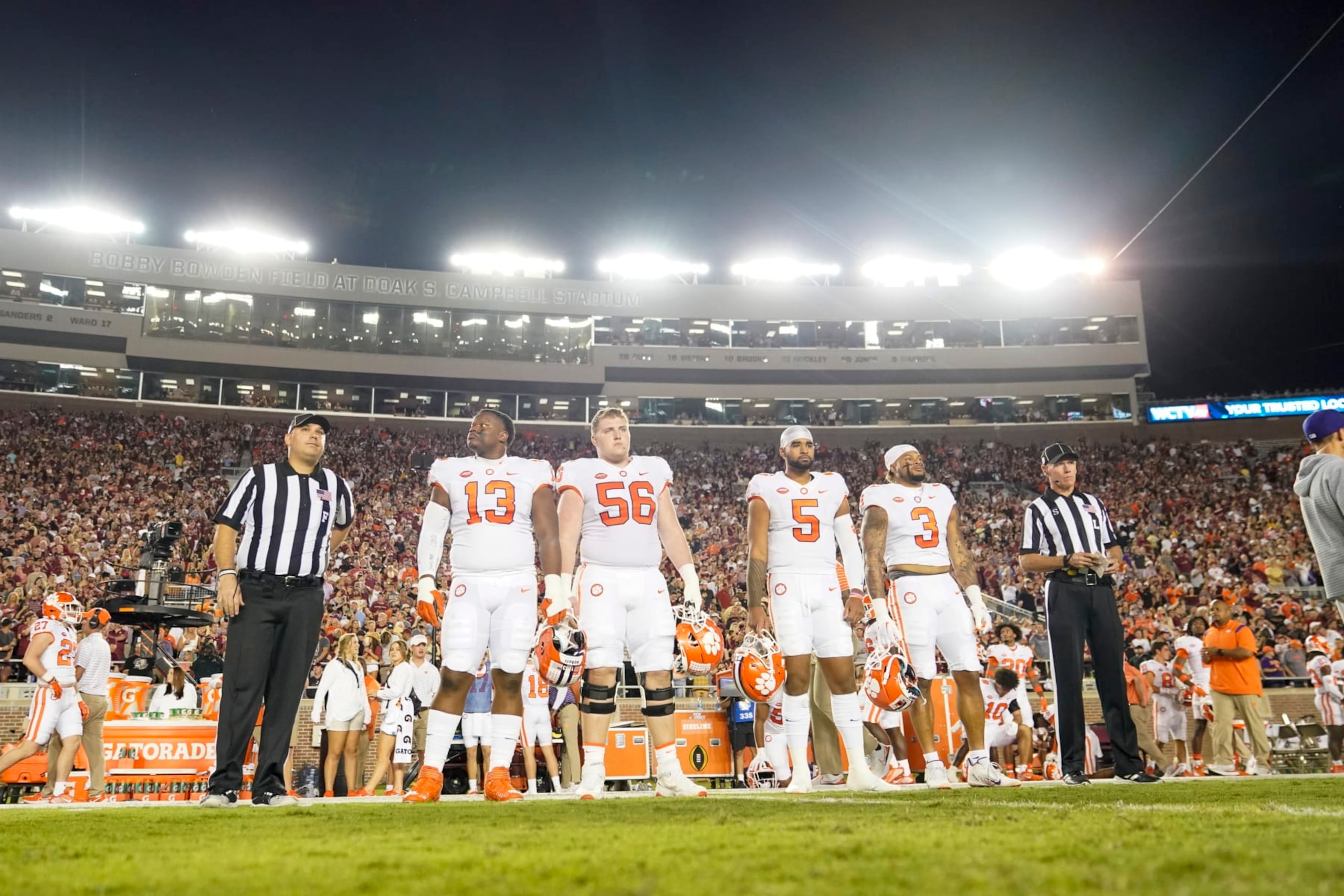 TALLAHASSEE, FL - OCTOBER 15: Clemson Tigers captains Clemson Tigers defensive tackle Tyler Davis (13), Clemson Tigers offensive lineman Will Putnam (56), Clemson Tigers quarterback DJ Uiagalelei (5)] and Clemson Tigers defensive end Xavier Thomas (3) line up before the Clemson Tigers game against the Florida State Seminoles on October 15, 2022, at Doak Campbell Stadium in Tallahassee, FL. (Photo by Chris Leduc/Icon Sportswire via Getty Images)